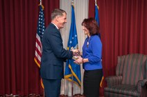 HANSCOM AIR FORCE BASE, Mass. – Retired Lt. Gen. Ted F. Bowlds, former Electronic Systems Center commander, congratulates Cynthia Morgiewicz, International Affairs and Foreign Military Sales branch chief, while officiating her retirement ceremony at the Minuteman Commons Dec. 7. Morgiewicz retired after nearly 40 years of federal government service. (U.S. Air Force photo by Rick Berry)
