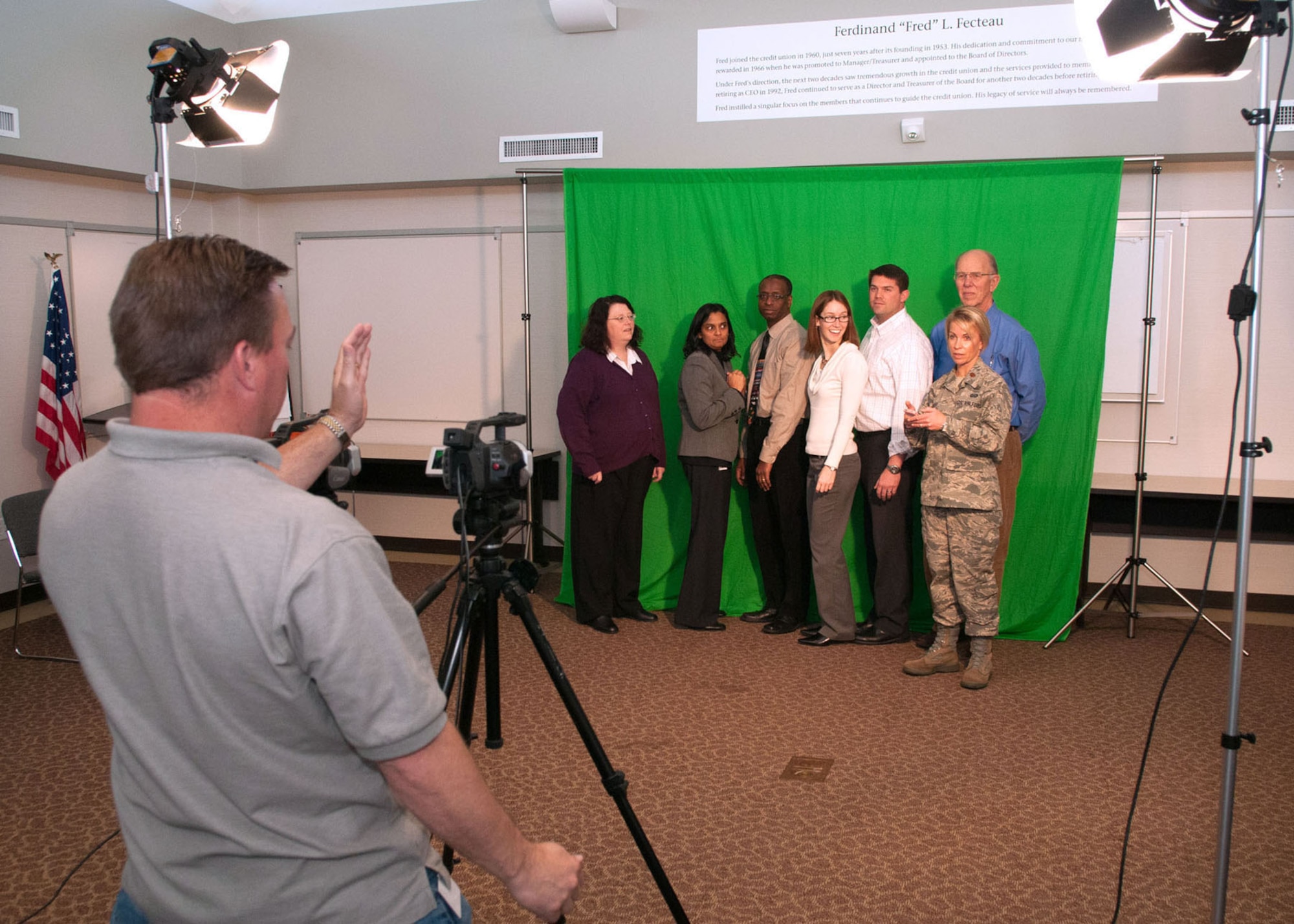 HANSCOM AIR FORCE BASE, Mass. – Members of the Battle Management Directorate prepare to record a holiday greeting for Capt. Cha O’Connor, who is deployed, with the help of Joe Keller from Operation Best Wishes at the Hanscom Federal Credit Union Dec. 6. Operation Best Wishes is an annual campaign held during the holiday season to help military families, friends and co-workers stay connected to deployed servicemembers in a memorable way. (U.S. Air Force photo by Rick Berry)