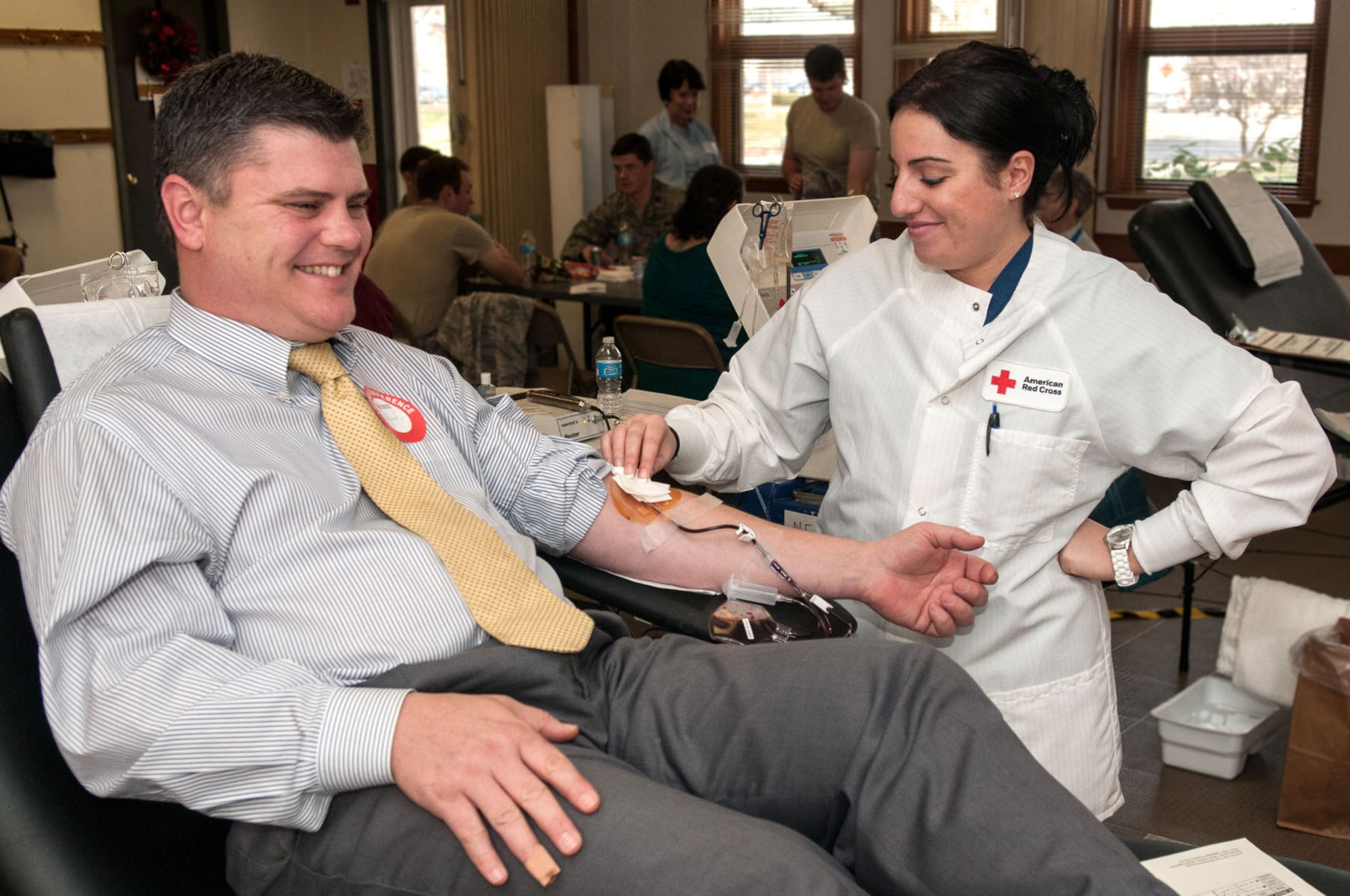 HANSCOM AIR FORCE BASE, Mass. -- Natasha Desaavedra, a Red Cross staff member, draws blood from A.J. Bonoldi Dec. 5 at the base chapel annex during a blood drive. For more information on donating blood through the Red Cross, visit www.redcross.org/donate/give. (U.S. Air Force photo by Rick Berry)