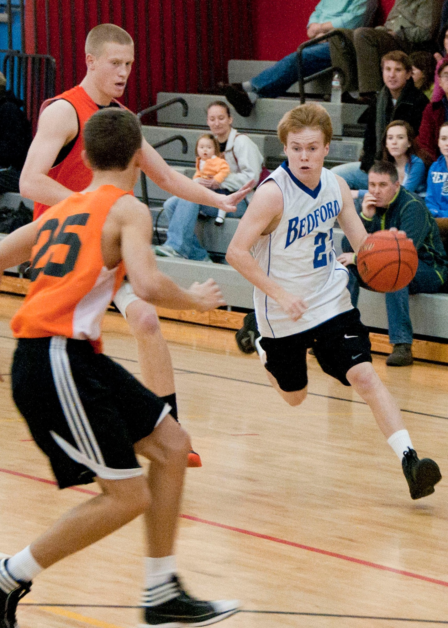 HANSCOM AIR FORCE BASE, Mass. -- Ben Johnson, a Bedford High School basketball player, dribbles past an Ipswich High School defender during a varsity basketball game at the Hanscom Fitness and Sports Center Dec. 8. The two teams played after a girls’ varsity game between Bedford High School and New Mission High School. (U.S. Air Force photo by Mark Wyatt)