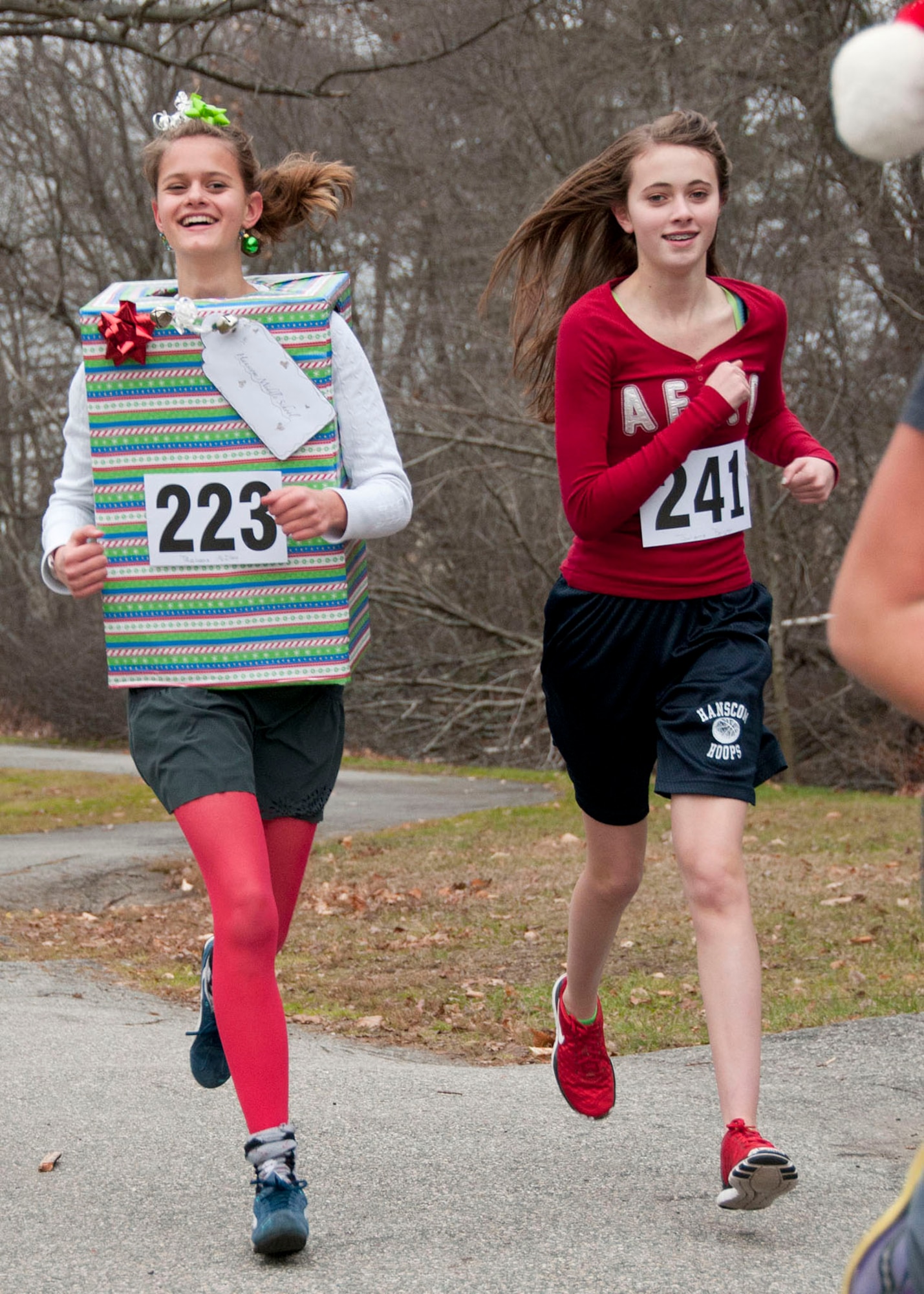 HANSCOM AIR FORCE BASE, Mass. -- Rebecca Mcllece (left) and Julianna Byington, students at Hanscom Middle School, participate in the Jingle Bell Run through Castle Park Dec. 7. Participants were asked to donate funds or food for the Merrimack Valley Food Bank, concluding the school’s month-long hunger awareness campaign, highlighting the problem of hunger in the United States. (U.S. Air Force photo by Mark Wyatt)