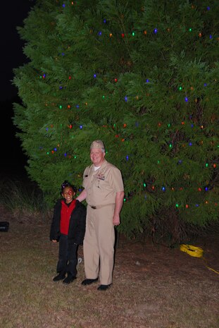 Capt. Thomas Bailey, Joint Base Charleston deputy commander, poses with Zoe Johnson, daughter of Army SGT. Derrick Johnson, after lighting the Holiday Tree Dec. 13, 2012,  at the JB Charleston – Weapons Station, S.C. (Courtesy photo) 