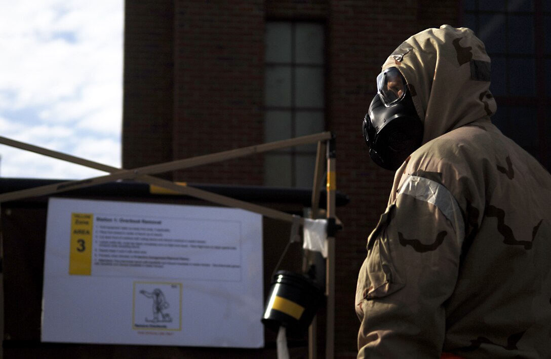 An aircrew flight equipment technician with the 1st Operations Support Squadron prepares for a pilot de-contamination exercise at Langley Air Force Base, Va., Dec. 7, 2012.  AFE technicians play a direct role in the event aircrew members are contaminated, and train regularly through exercises. (U.S. Air Force photo by Staff Sgt. Katie Gar Ward / Released)