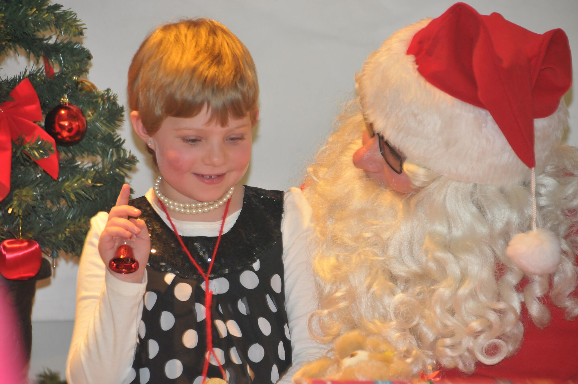 Lauren Sharp tells Santa what is on her Christmas list at the Flight to the North Pole at the 128th Air Refueling Wing, Milwaukee, Dec. 8, 2012.  Twelve families with children in the care of Children's Hospital of Wisconsin participated in the event put on by military and civilian volunteers.  (Air National Guard photo by Staff Sgt. Jenna Hildebrand / released).