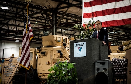 Christopher Miller, Space and Naval Warfare Systems Center Atlantic executive director, speaks to invited guests and workers who helped integrate the mine-resistant, ambush-protected vehicles at a ceremony held to commemorate the rapid acquisition, integration of electronics and delivery of more than 27,000 MRAP vehicles sent to Iraq and Afghanistan, Dec. 10, 2012, from the SPAWAR integration facility on Joint Base Charleston – Weapons Station, S.C. The team at SPAWAR initially integrated five vehicles a day, but when demand for the vehicles rose, the team stepped production up to integrating 50 vehicles a day. The team even reached the lofty goal of integrating 75 MRAPSs in one day. (U.S. Air Force photo/ Senior Airman Dennis Sloan)