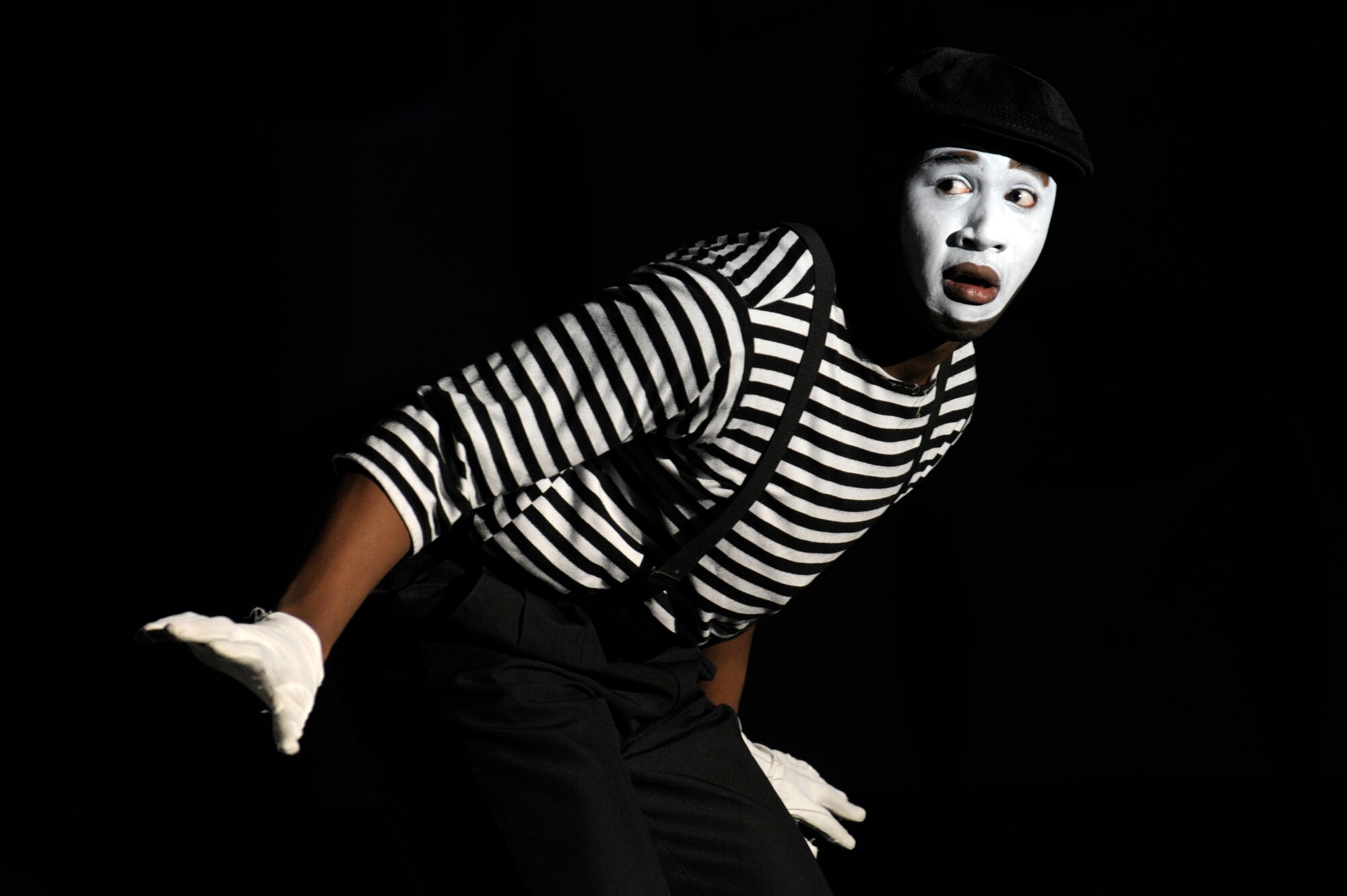 U.S. Air Force Senior Airman Charles Cooper, 86th Vehicle Readiness Squadron vehicle operator journeyman stationed at Ramstein Air Base, Germany, performs a mime routine during a Tops in Blue performance at the Base Theater Dec. 7, 2012, Eielson Air Force Base, Alaska. (U.S. Air Force photo/Airman 1st Class Peter Reft)