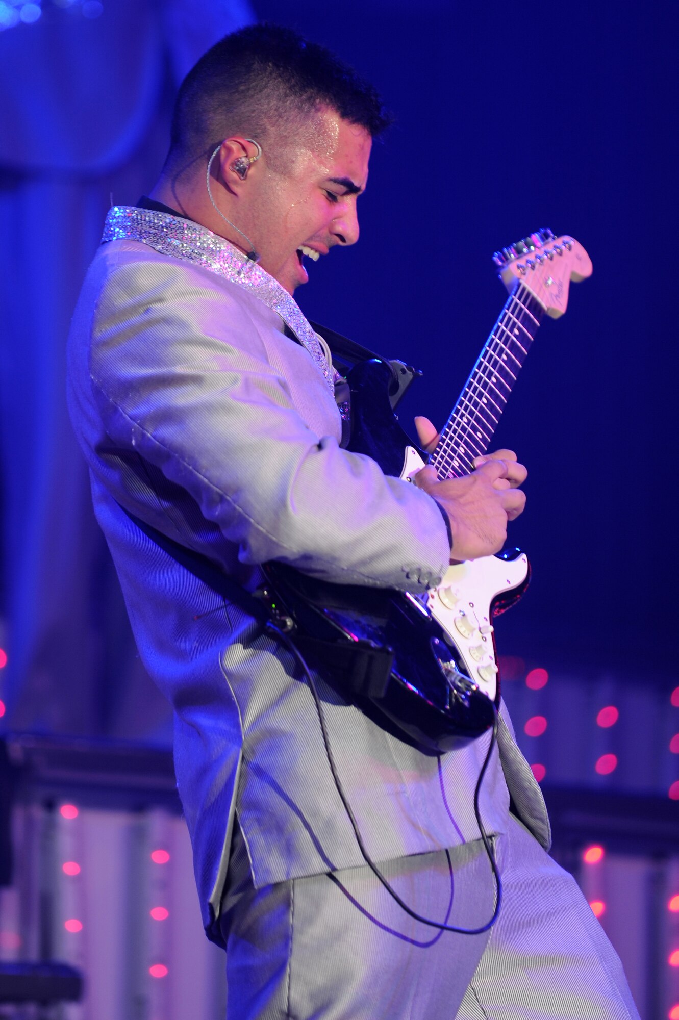 U.S. Air Force Senior Airman Kenneth Del Valle Ruiz, 1st Maintenance Operations Squadron maintenance scheduler journeyman from Joint Base Langley-Eustis, Va., rocks the electric guitar during a Tops in Blue performance at the Base Theater Dec. 8, 2012, Eielson Air Force Base, Alaska. Tops in Blue provides expeditionary entertainment for Air Force members, families and members of the local community. (U.S. Air Force photo/ Staff Sgt. Jim Araos)