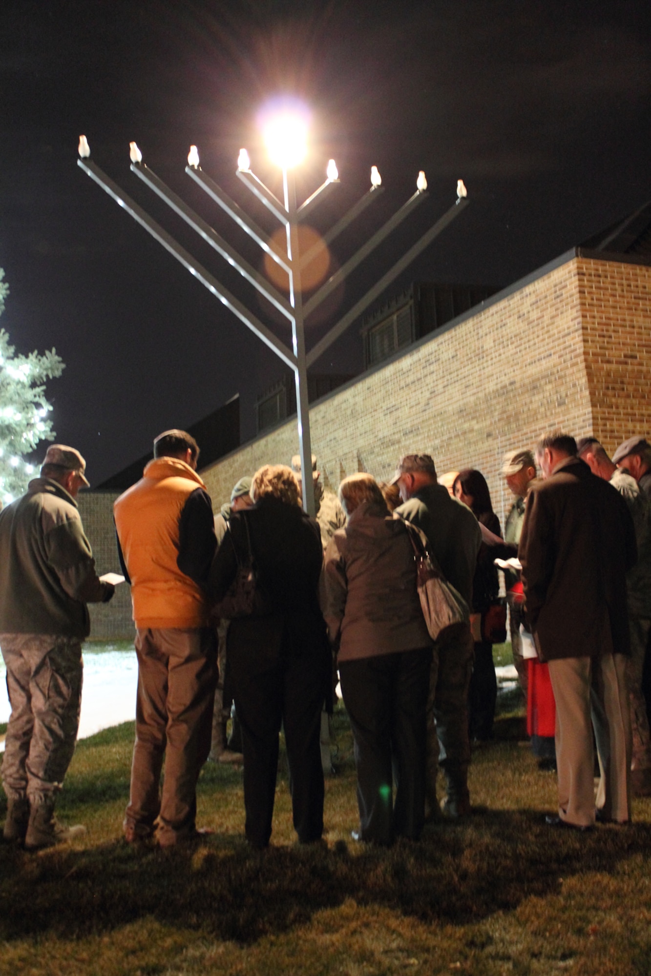 PETERSON AIR FORCE BASE, Colo. -- The Peterson chapel held a menorah lighting ceremony Dec. 10 at the chapel. Chaplain (Col.) Brett Oxman, rabbi and Air Force Space Command chaplain, talked about the history of Hanukkah and then lit the menorah. After the lighting, the group went inside the chapel and lit individual Hanukkah candles, followed by refreshments, fellowship and a game. Hanukkah ends at nightfall Dec. 16. (U.S. Air Force photo/Bill Davis)