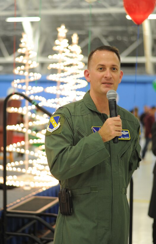 Col. Bill Knight, 11th Wing/Joint Base Andrews commander, thanks the volunteers and event coordinators moments prior to introducing Santa Claus at the 25th Annual Parents and Children Fighting Cancer Christmas Party, Dec. 8, 2012 in Hangar 3 on Joint Base Andrews, Md. The annual PCFC event allows military families whose lives have been affected by cancer to come together and enjoy a free holiday celebration with food, performances, displays and special visit from Mr. and Mrs. Santa Claus. (U.S. Air Force photo/Senior Airman Bahja J. Jones) 
