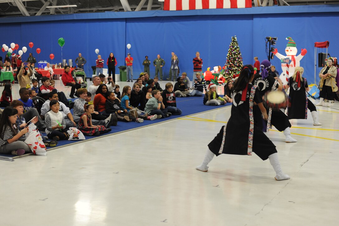 Students from the Chin Hamaya Culture Center perform an Okinawan Taiko drum dance during the 25th Annual Parents and Children Fighting Cancer Christmas Party, Dec. 8, 2012 in Hangar 3 on Joint Base Andrews, Md. The dance group shared their message of “peace through understanding each other’s culture” to the guests at the PCFC event. (U.S. Air Force photo/Senior Airman Bahja J. Jones))