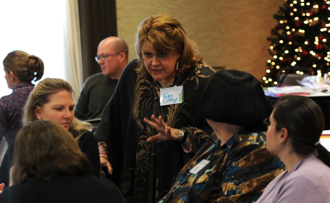 Julie Coffey, Military Child Education Coalition instructor, works with groups to create plans tailored to address the needs of military children in their community during a Living in the New Normal workshop at the Hilton Garden Inn in Rapid City, S.D., Dec. 5, 2012. The course, developed by the MCEC, was designed to provide attendees a broader perspective on how to help military children deal with change, deployments, loss and similar issues. (U.S. Air Force photo by Airman 1st Class Hrair H. Palyan/Released)