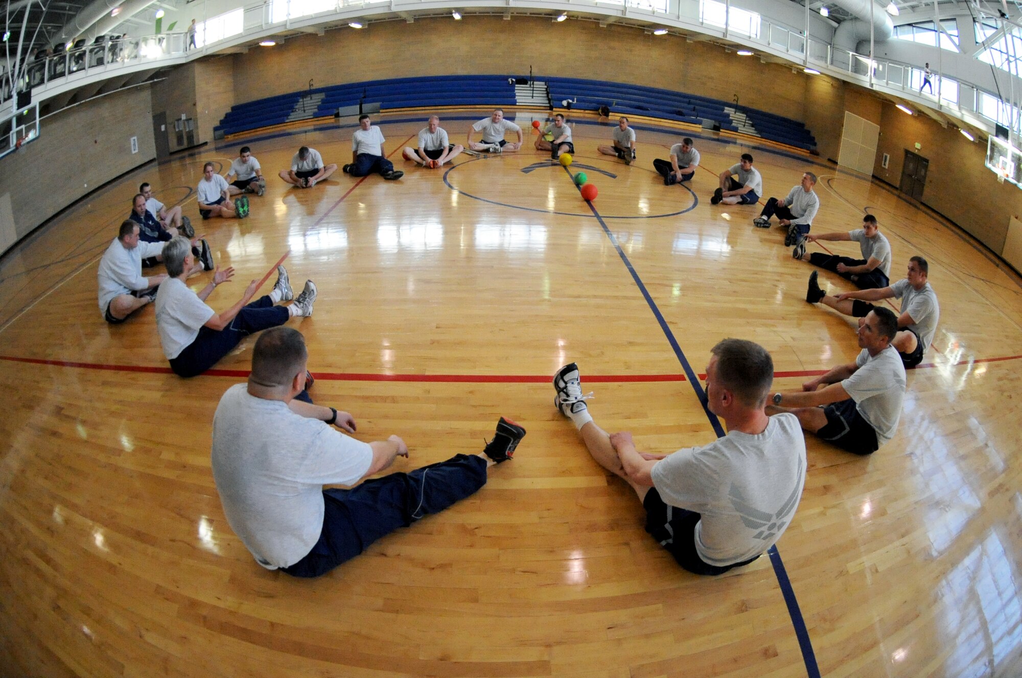 Reservists from the 419th Fighter Wing stretch after a game of dodge ball at the Warrior Fitness Center here Dec. 11. The game was part of a team-building PT session for about 20 Airmen enrolled in the non-commissioned officer leadership development course, a two-week course that provides training to mid-level enlisted personnel and helps shape future leaders. (U.S. Air Force photo/Alex Lloyd) 