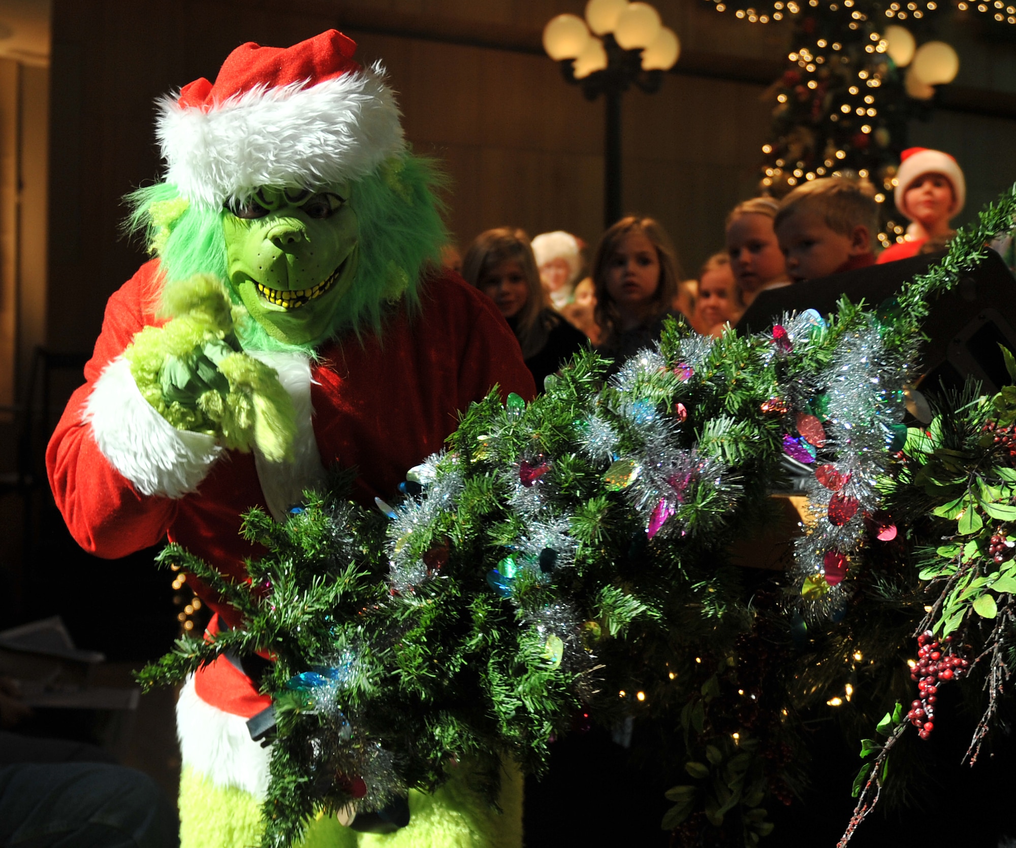 The Grinch makes a special appearance during the reading of “How the Grinch stole Christmas” read by Mrs. Claus. The U.S. Air Force Heartland of America Band from Offutt Air Force Base performed various holiday favorites at the Holland Performing Arts Center in Omaha, Neb., Dec. 7. (U.S. Air Force Photo by Jeff W. Gates/Released)
