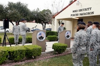 Airmen from the 902nd Security Forces Squadron attend the command dedication of their Operation Iraqi Freedom and Operation Enduring Freedom Defenders Wall Dec. 6. The memorial wall is in the 902nd SFS building at Joint Base San Antonio-Randolph honoring nine fallen Airman. (U.S. Air Force photo by Joshua Rodriguez)
