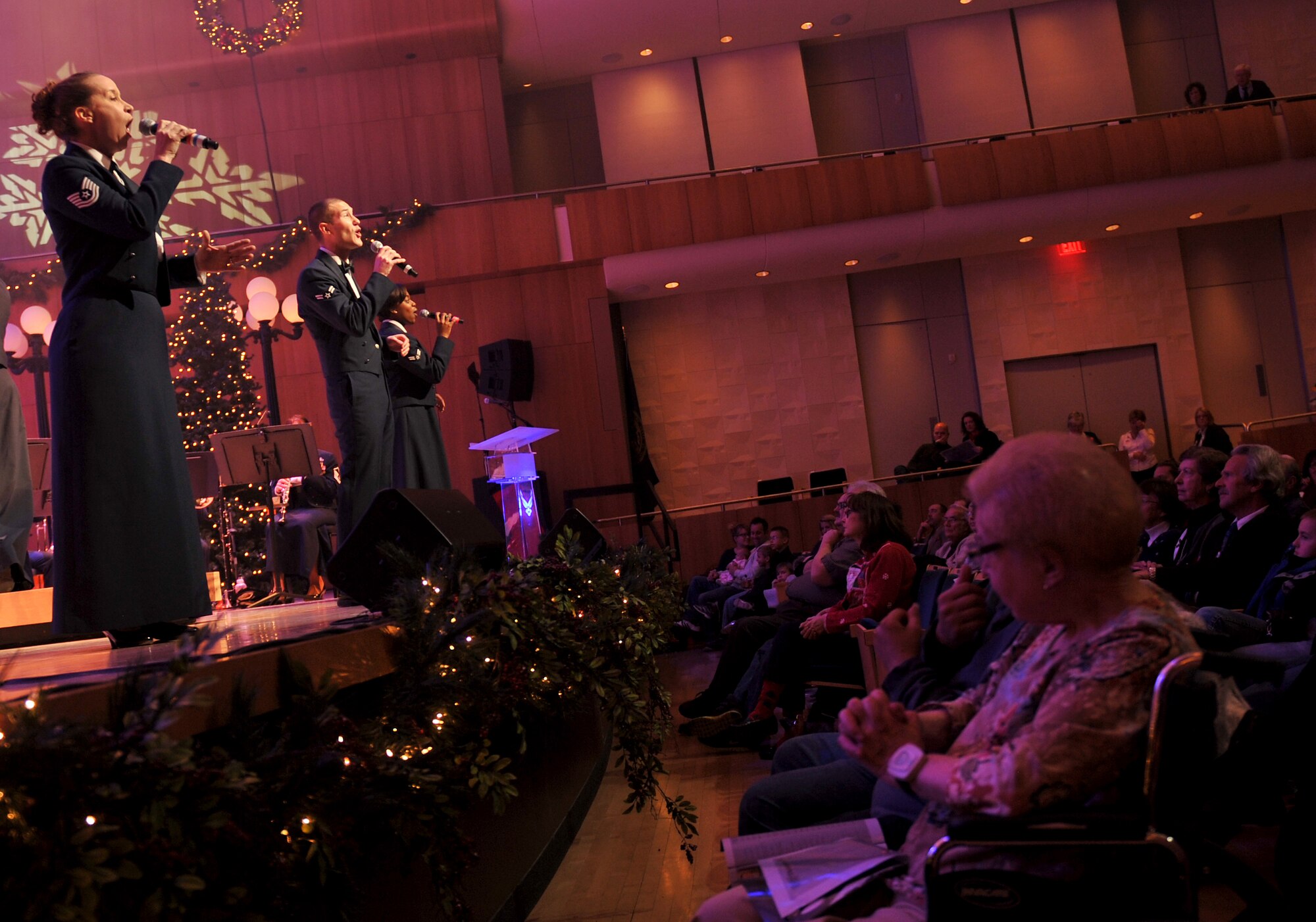 The U.S. Air Force Heartland of America Band, sings a holiday favorite. The band performed various holiday favorites at the Holland Performing Arts Center in Omaha, Neb., Dec. 7, and welcomed patrons from all over the Omaha area to a free concert. (U.S. Air Force photo by Jeff W. Gates/Released)