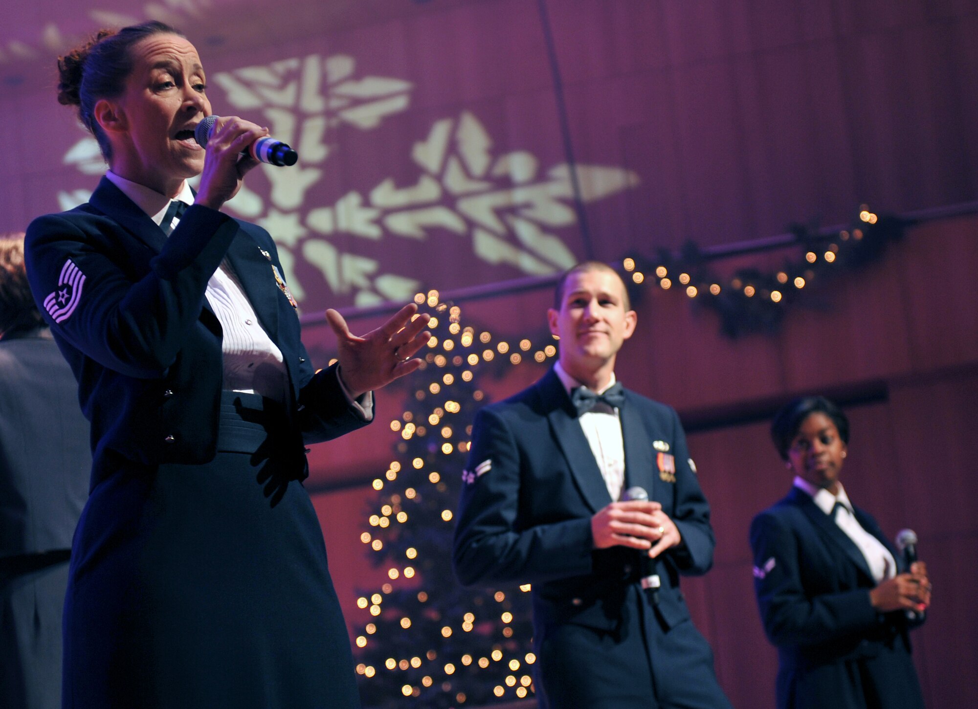 Tech. Sgt. Rebecca Packard, vocalist for the U.S. Air Force Heartland of America Band, sings a holiday favorite. The band performed various holiday favorites at the Holland Performing Arts Center in Omaha, Neb., Dec. 7, and welcomed patrons from all over the Omaha area to a free concert. (U.S. Air Force photo by Jeff W. Gates/Released)