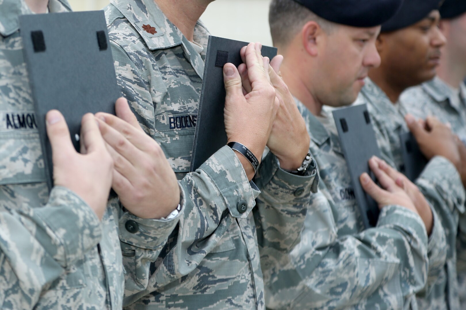 Airmen from the 902nd Security Forces Squadron attend the command dedication of their Operation Iraqi Freedom and Operation Enduring Freedom Defenders Wall Dec. 6. The memorial wall is in the 902nd SFS building at Joint Base San Antonio-Randolph honoring nine fallen Airman. (U.S. Air Force photo by Joshua Rodriguez)