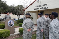 Airmen from the 902nd Security Forces Squadron attend the command dedication of their Operation Iraqi Freedom and Operation Enduring Freedom Defenders Wall Dec. 6. The memorial wall is in the 902nd SFS building at Joint Base San Antonio-Randolph honoring nine fallen Airman. (U.S. Air Force photo by Joshua Rodriguez)