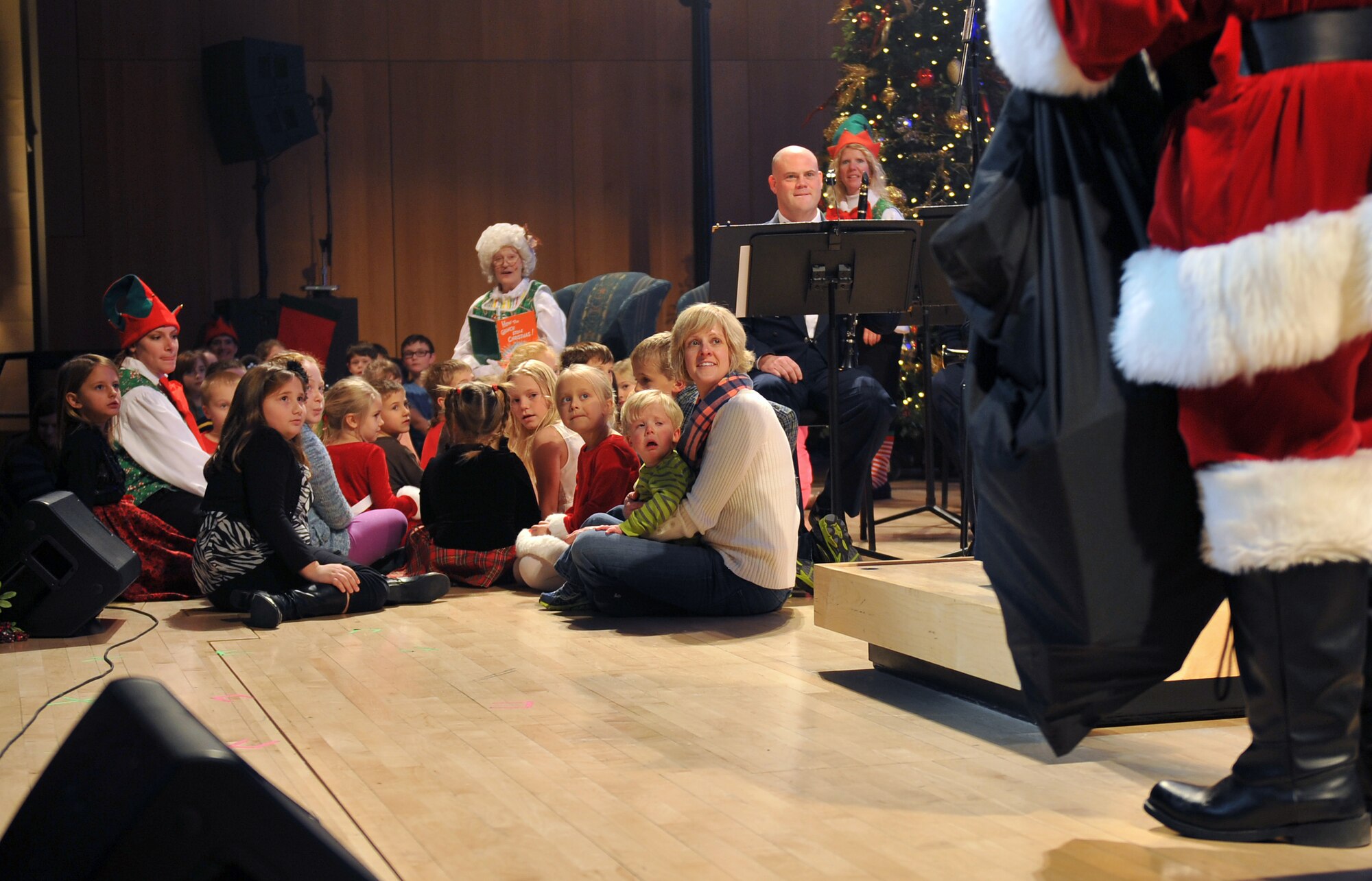 Children show their anticipation for Santa before he sits down to read a holiday story with Mrs. Claus. The U.S. Air Force Heartland of America Band from Offutt Air Force Base performed various holiday favorites at the Holland Performing Arts Center in Omaha, Neb., Dec. 7. The 2012 concert theme was “A Hometown Holiday” welcoming patrons from all over the Omaha area to a free concert. The Heartland of America Band works in conjunction with the Omaha World Herald to put the concert series together each year. (U.S. Air Force photo by Jeff W. Gates/Released)