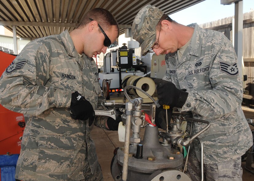 Staff Sgts. Daniel Hamden and Jeremy Coker, 2nd Civil Engineer Squadron water and fuels systems maintenance craftsmen rebuild a hydrant refueling control valve for large frame aircraft on Barksdale Air Force Base, La., Dec. 3. The hydrant can pump more than 400 gallons of fuel per minute into a B-52H Stratofortress. (U.S. Air Force photo/Senior Airman Kristin High)

