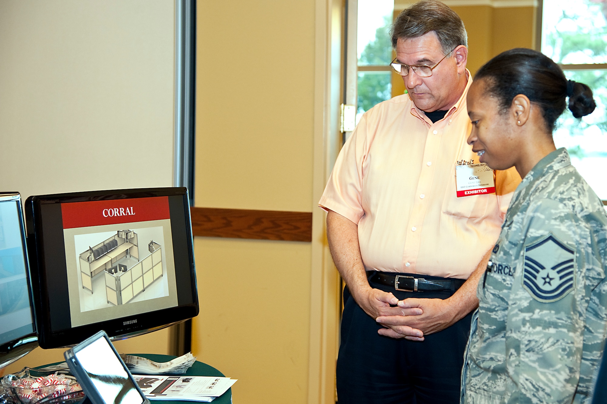 U.S. Air Force Master Sgt. Cherise McKinnon, NCO in charge of aviation resource management system of 34th Special Operations Squadron, views an example of a foldable desk during the Technology Expo at the Soundside Club at Hurlburt Field, Fla., Dec. 11, 2012. Vendors demonstrated equipment essential to completing the mission including test equipment, secured radio communications, data transfer security, all the way to foldable desks.