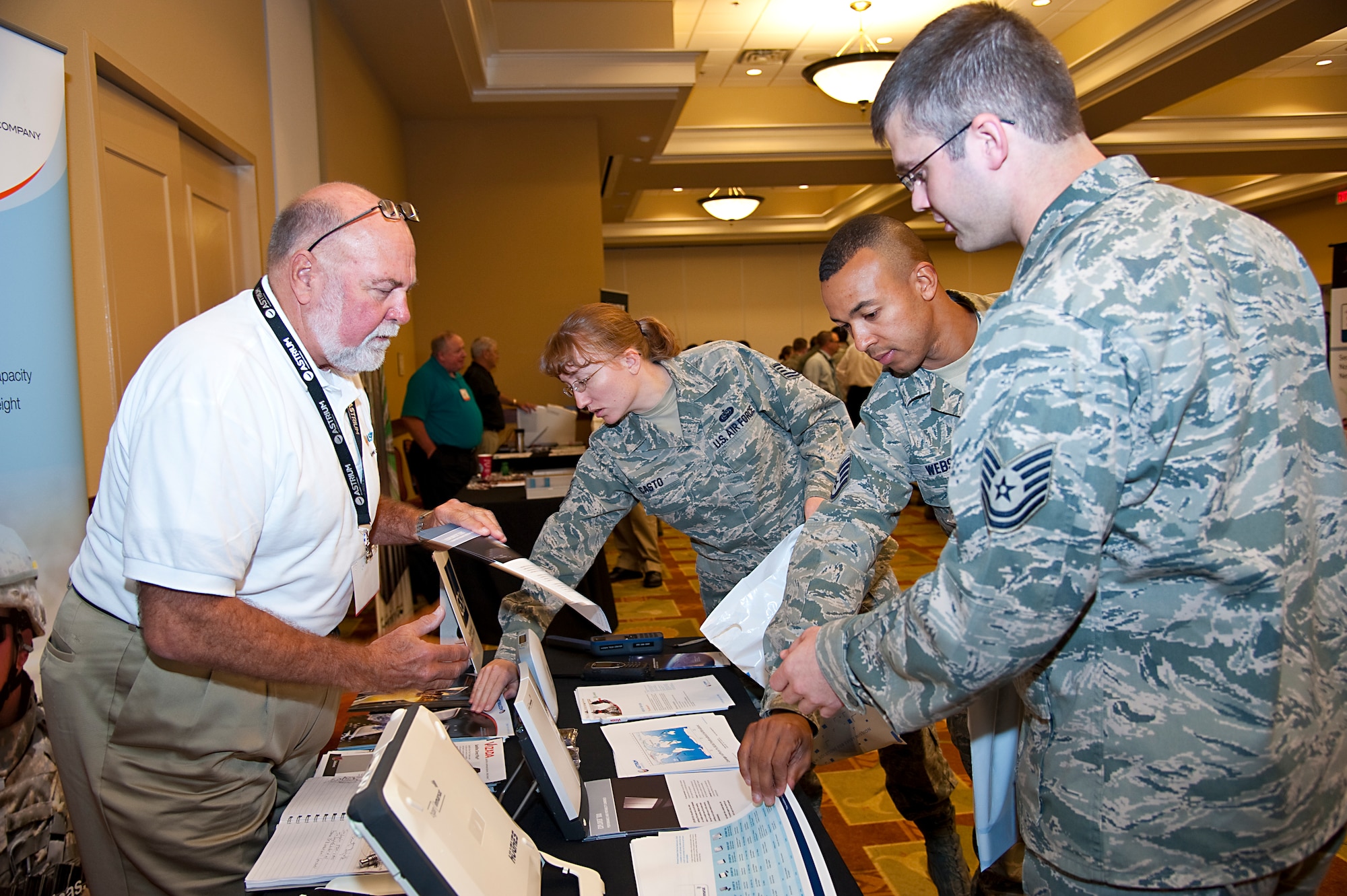 Airmen gather information on products during the Technology Expo at the Soundside Club at Hurlburt Field, Fla., Dec. 11, 2012. Over 30 vendors showcased their products to give base personnel the opportunity to see the latest technology in action.