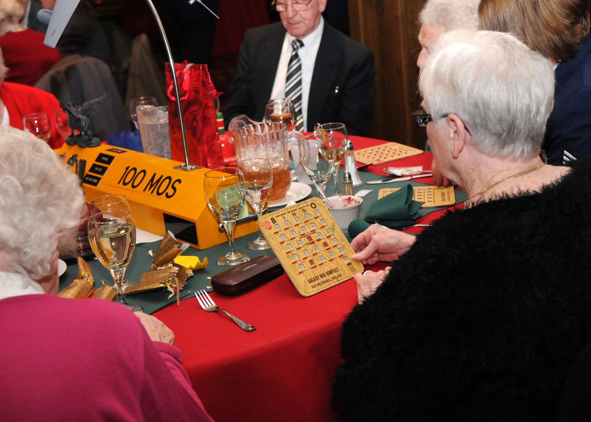 Senior citizens play bingo during the Senior Citizens Christmas party Dec. 12, 2012, at RAF Mildenhall, England. The Christmas party included lunch with service members, a raffle, bingo and a visit from Santa Claus. (U.S. Air Force photo by Airman 1st Class Kelsey Waters/Released)