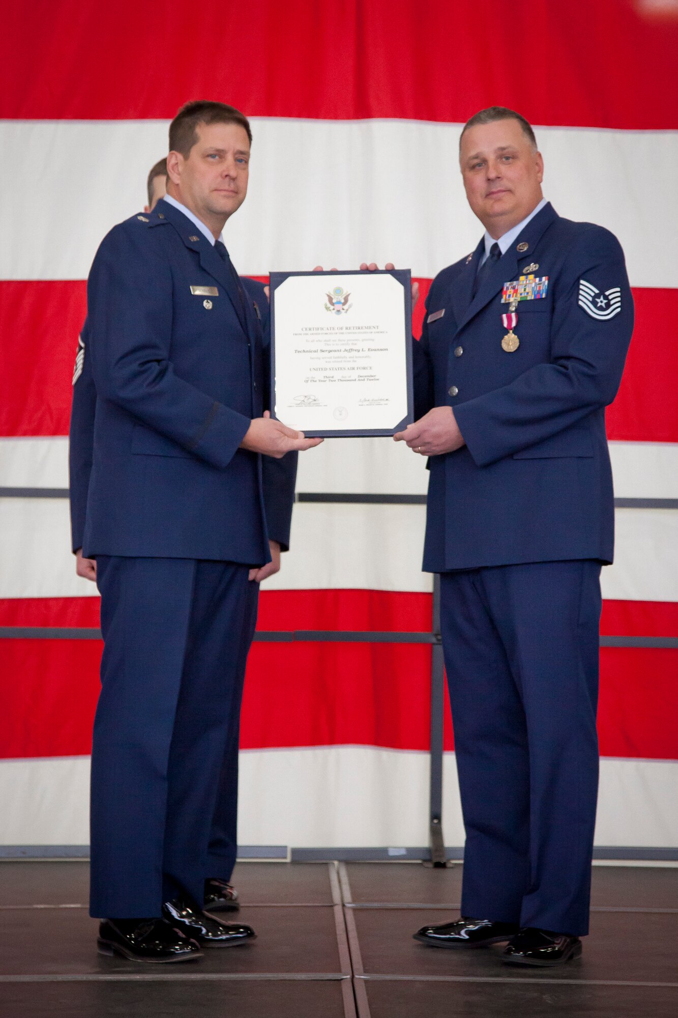 Lt. Col. Marvin P. Schaitel, 934th Maintenance Group deputy commander, presents Tech. Sgt. Jeffrey L. Evanson with his certificate of retirement.  Evanson retires from the 934 MXG, Minneapolis-St. Paul AIr Reserve Station, Minn., after 20 years of service. (U.S. Air Force Photo/Shannon McKay)