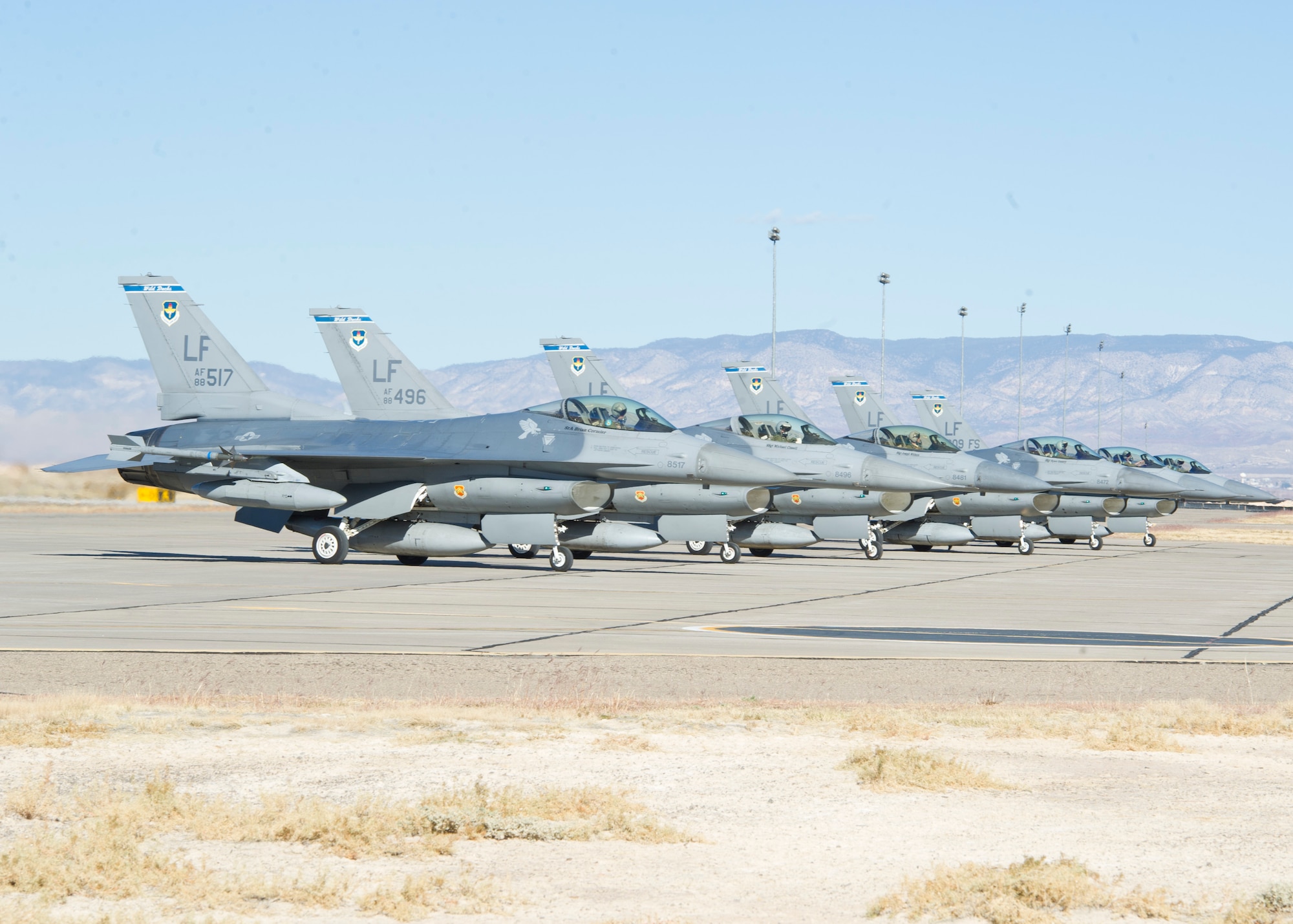 Six F-16 Fighting Falcons from the 309th Fighter Squadron, 56th Fighter Wing, Luke Air Force Base, Ariz., stage at the end of the runway at Holloman Air Force Base, N.M., Dec. 7. The 309 FS deployed 18 F-16s and 190 supporting personnel to Holloman AFB to test infrastructure, range, and airspace capabilities to support the F-16 formal training unit, which will be moving to Holloman AFB. While here, the F-16s will fly 24 sorties per day. (U.S. Air Force photo by Senior Airman DeAndre Curtiss / Released) 
