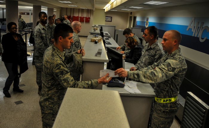 More than 50 quarterly award winners including Airmen, Sailors and civilians receive their boarding pass during an incentive flight Dec. 6, 2012, at Joint Base Charleston – Air Base. The incentive flight involved two C-17s, which were conducting air drop training missions at Joint Base Charleston’s – North Auxiliary Air Field, (U.S. Air Force photo/ Airman 1st Class Jared Trimarchi)