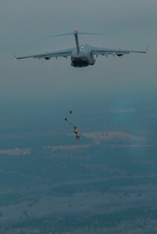 A C-17 Globemaster III, assigned to the 437th Airlift Wing at Joint Base Charleston, S.C., performs an air drop during an incentive flight Dec. 6, 2012, at JB Charleston’s – North Auxiliary Air Field. More than 50 quarterly award winners attended an incentive flight involving two C-17s, which were conducting air drop training missions. (U.S. Air Force photo/ Airman 1st Class Jared Trimarchi)