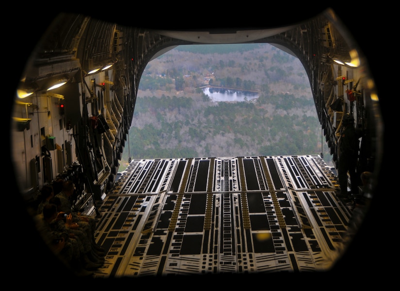 Quarterly award winners from various units at Joint Base Charleston, S.C.,  look out the back of a C-17 Globemaster III during an incentive flight Dec. 6, 2012, over the Lowcountry of South Carolina. More than 50 quarterly award-winning Airmen, Sailors and civilians attended the incentive flight onboard two C-17s which were conducting air drop training missions at JB Charleston’s – North Auxiliary Air Field. (U.S. Air Force photo/ Airman 1st Class Jared Trimarchi)