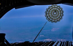 A parachute pulls a pallet out of the rear of C-17 Globemaster III from the 437th Airlift Wing at Joint Base Charleston – Air Base, S.C. The Dec. 6, 2012, mission also hosted an incentive flight and more than 50 JB Charleston quarterly award winners flew onboard two C-17s which were conducting air drop training missions at JB Charleston’s – North Auxiliary Air Field. (U.S. Air Force photo/ Airman 1st Class Jared Trimarchi)