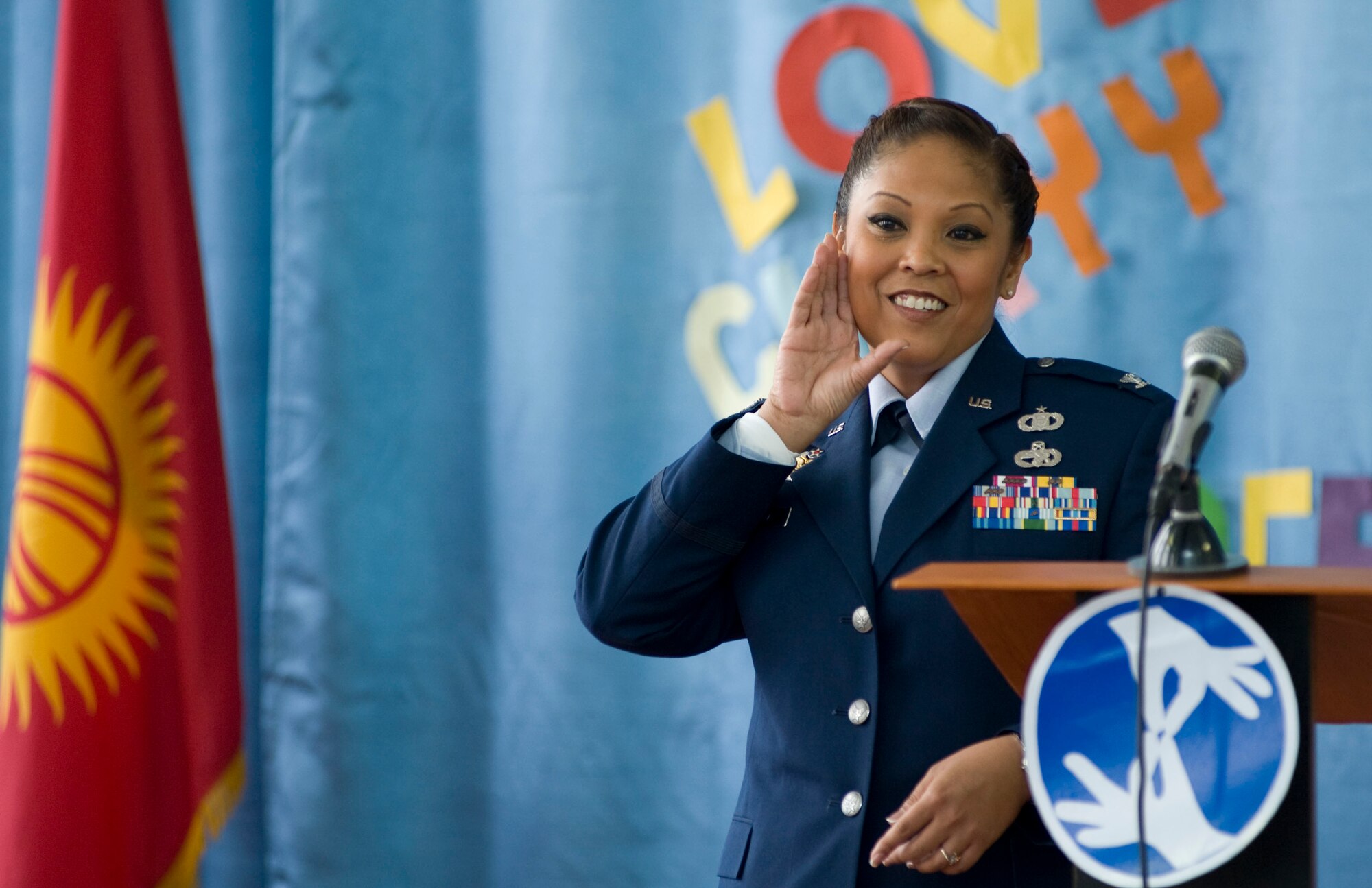 Col. Shirlene Ostrov, 376th Expeditionary Mission Support Group commander, signs to students and distinguished guests during the Bishkek School for the Deaf dedication ceremony in Bishkek, Kyrgyzstan, Dec. 11, 2012. Ostrov continuously makes an effort to learn sign language with every visit to the school. (U.S. Air Force photo / Staff Sgt. Stephanie Rubi)
