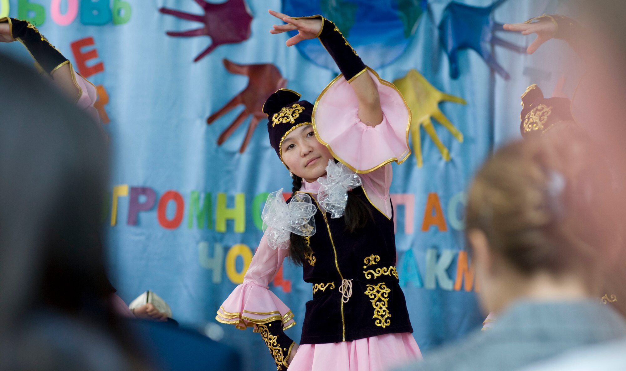 A Bishkek School for the Deaf student performs a dance for more than 140 guests during a dedication ceremony in Bishkek, Kyrgyzstan, Dec. 11, 2012. The school accepts and boards hearing impaired children from across Kyrgyzstan, who range from kindergarten to high school age.  (U.S. Air Force photo / Staff Sgt. Stephanie Rubi)