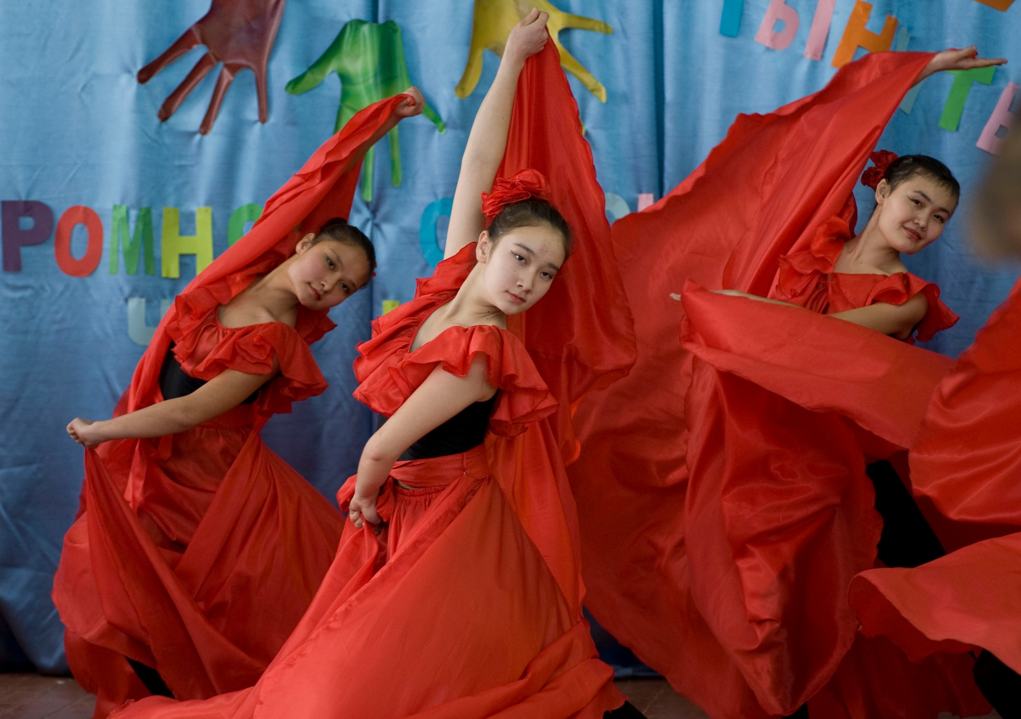Students from the Bishkek School for the Deaf perform a Latin dance for Transit Center at Manas Airmen during a dedication ceremony in Bishkek, Kyrgyzstan, Dec. 11, 2012. Students performed both native and foreign dances while signing. Though they attend the school for sign language, students also learn general and specialized subjects. (U.S. Air Force photo / Staff Sgt. Stephanie Rubi)