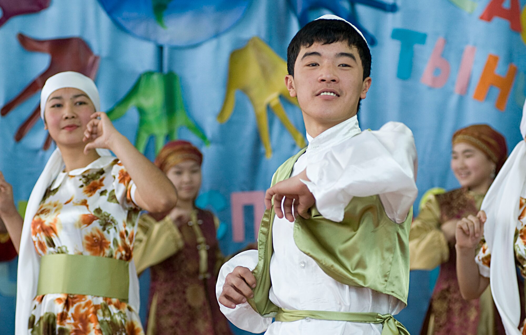 Bishkek School for the Deaf students performs a dance during a dedication ceremony in Bishkek, Kyrgyzstan, Dec. 11, 2012. Students shared smiles with audience members while signing and dancing to traditional Kyrgyz music. (U.S. Air Force photo / Staff Sgt. Stephanie Rubi)