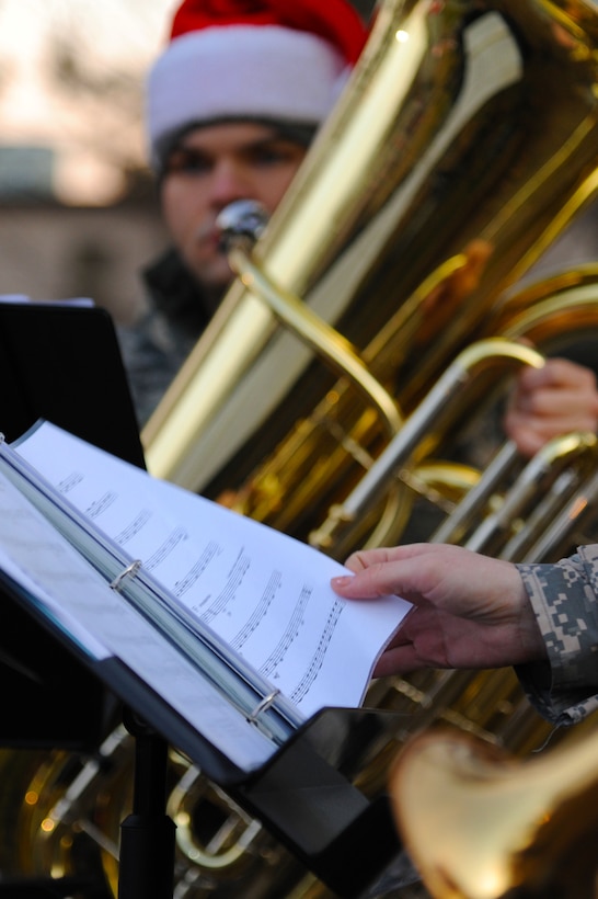 U.S. Army Sgt. Eric Hamilton, a tuba player with the U.S. Army Training and Doctrine Command Band Brass Quintet, waits for his moment to play during a performance at the annual Fort Eustis Christmas Tree Lighting celebration at Seay Plaza on Fort Eustis, Va., Dec. 6, 2012. The first recorded instance of a tree lighting on post was in 1955. (U.S. Air Force photo by Airman 1st Class Victoria Taylor/Released)