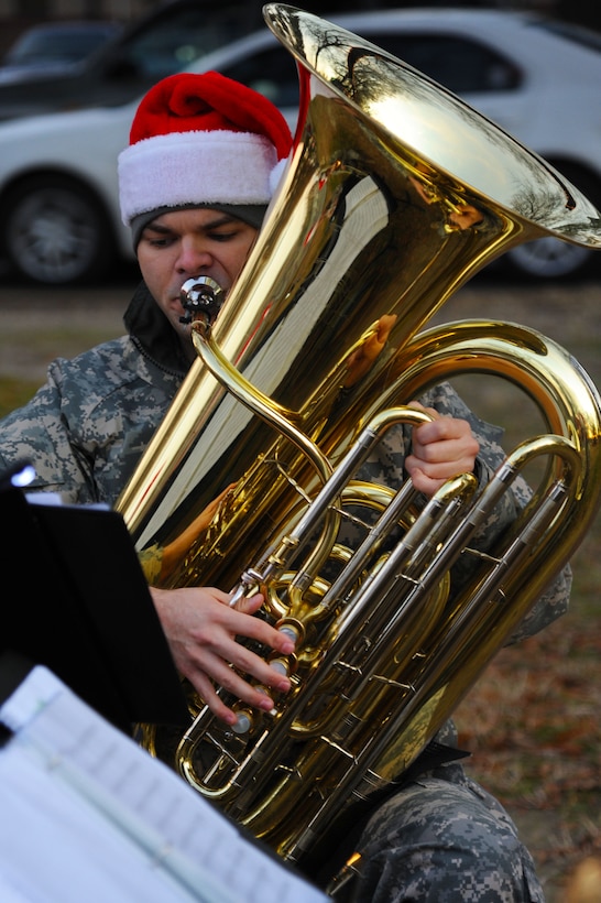 U.S. Army Sgt. Eric Hamilton, a tuba player with the U.S. Army Training and Doctrine Command Band Brass Quintet, reads sheet music while performing at the annual Fort Eustis Christmas Tree Lighting celebration at Seay Plaza on Fort Eustis, Va., Dec. 6, 2012. The TRADOC Band performed holiday standards, including “Here Comes Santa Claus,” “Deck the Halls,” “Frosty the Snowman,” and “Rudolph the Red-Nosed Reindeer.” (U.S. Air Force photo by Airman 1st Class Victoria Taylor/Released)