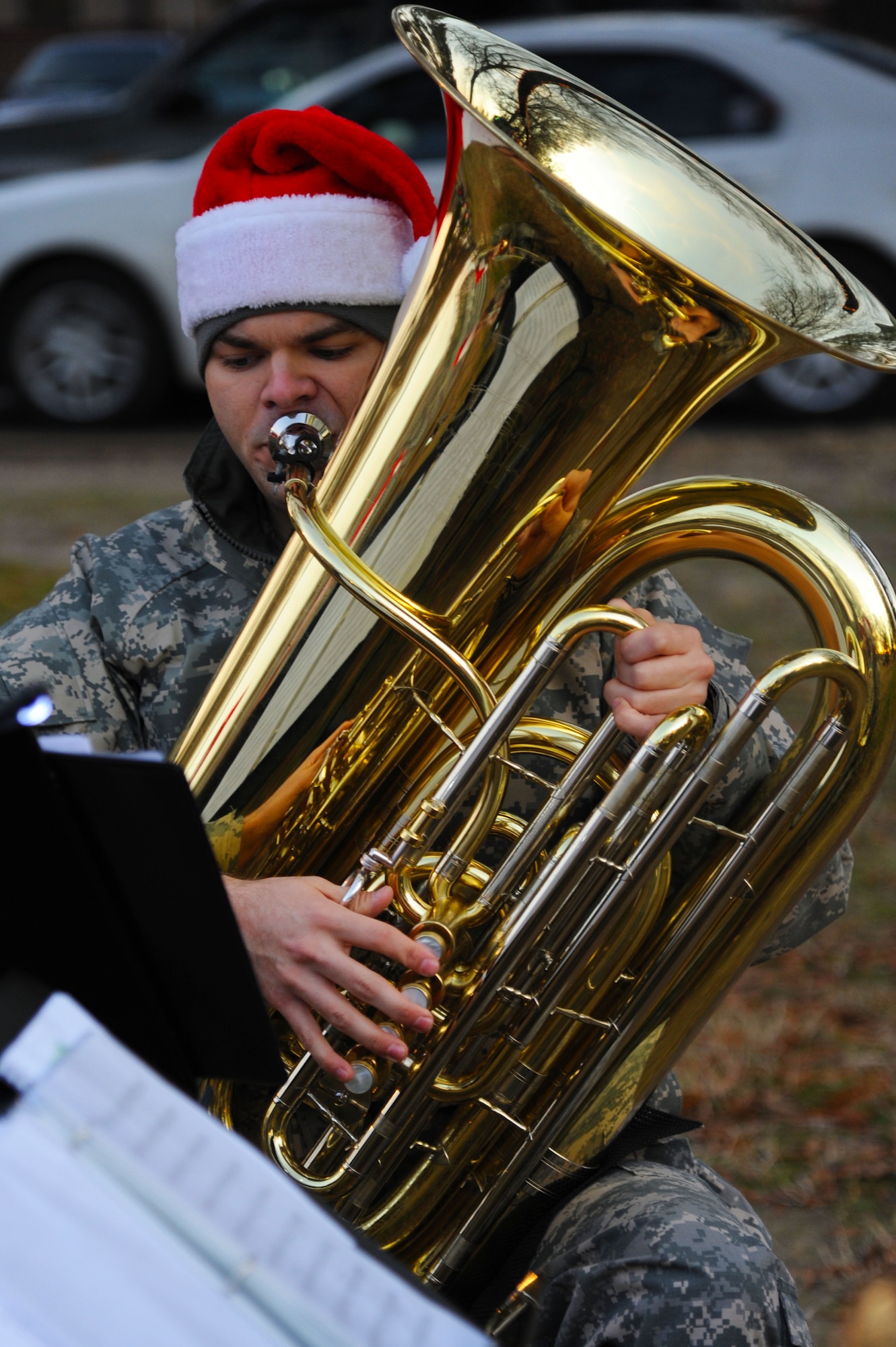 U.S. Army Sgt. Eric Hamilton, a tuba player with the U.S. Army Training and Doctrine Command Band Brass Quintet, reads sheet music while performing at the annual Fort Eustis Christmas Tree Lighting celebration at Seay Plaza on Fort Eustis, Va., Dec. 6, 2012. The TRADOC Band performed holiday standards, including “Here Comes Santa Claus,” “Deck the Halls,” “Frosty the Snowman,” and “Rudolph the Red-Nosed Reindeer.” (U.S. Air Force photo by Airman 1st Class Victoria Taylor/Released)