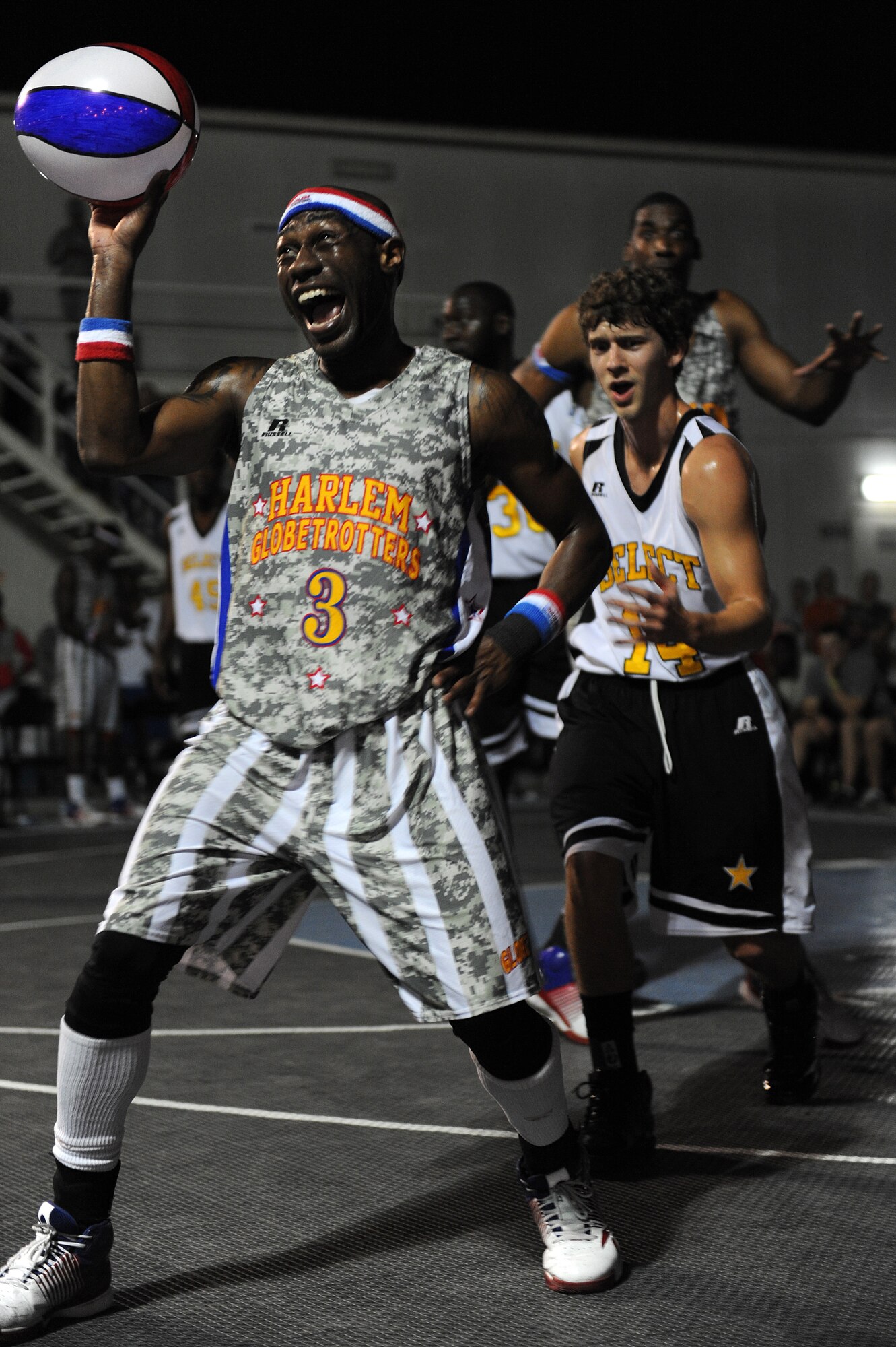 SOUTHWEST ASIA -- Harlem Globetrotter “Firefly" Fisher performs a "slow-motion" replay for the crowd during a performance at the 380th Air Expeditionary Wing Dec. 10, 2012. The "Ambassadors of Goodwill" performed for military audiences across the area of responsibility during their 11th Holiday Military Tour. (U.S. Air Force photo/Tech. Sgt. Christina M. Styer) (RELEASED)