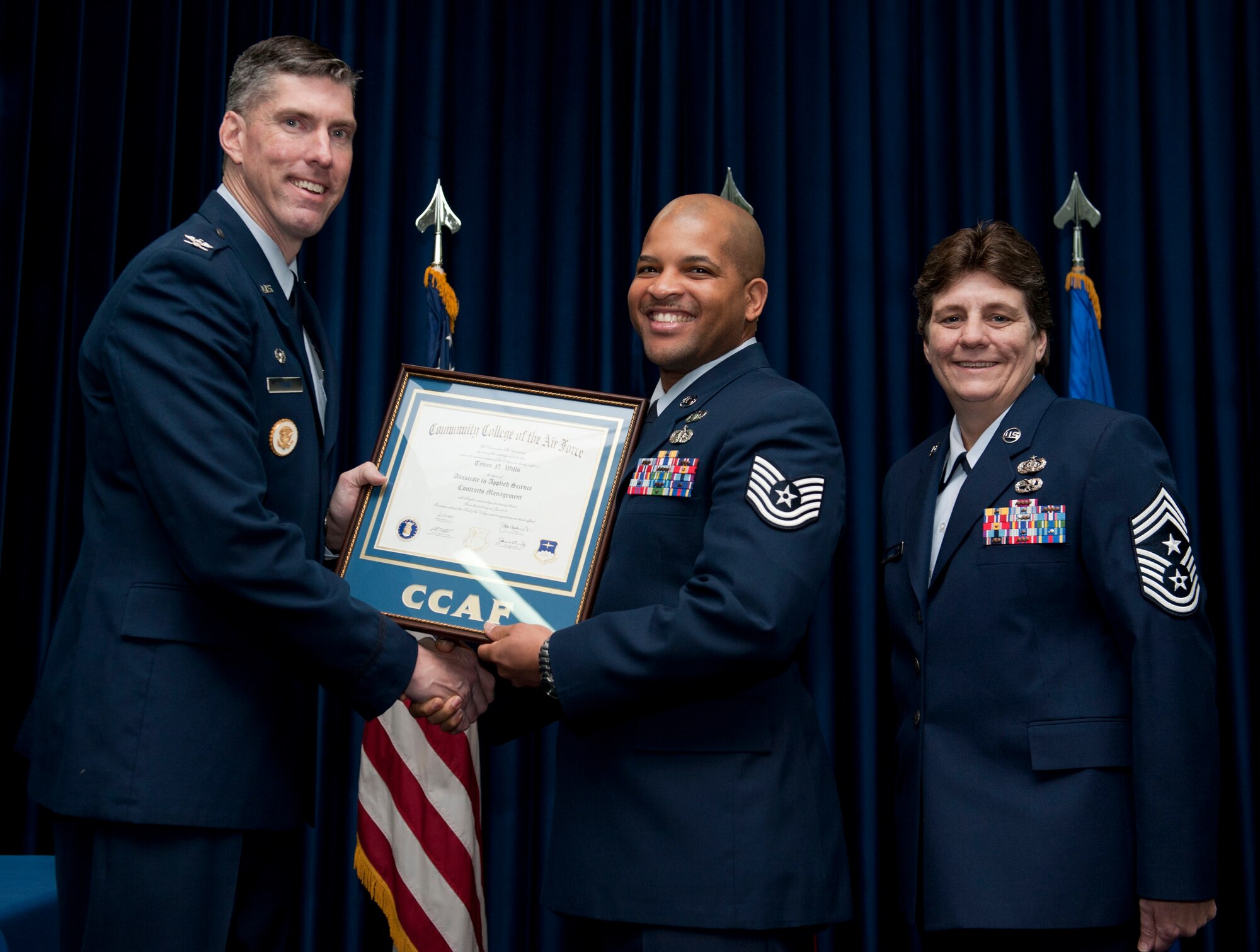Tech. Sgt. Tyson Wills, 39th Contracting Squadron, is awarded a degree from the Community College of the Air Force Dec. 7, 2012, at Incirlik Air Base, Turkey. The CCAF offers enlisted members the opportunity to earn associate degrees that relate to their Air Force Specialty Code. (U.S. Air Force photo by Senior Airman Clayton Lenhardt/Released)