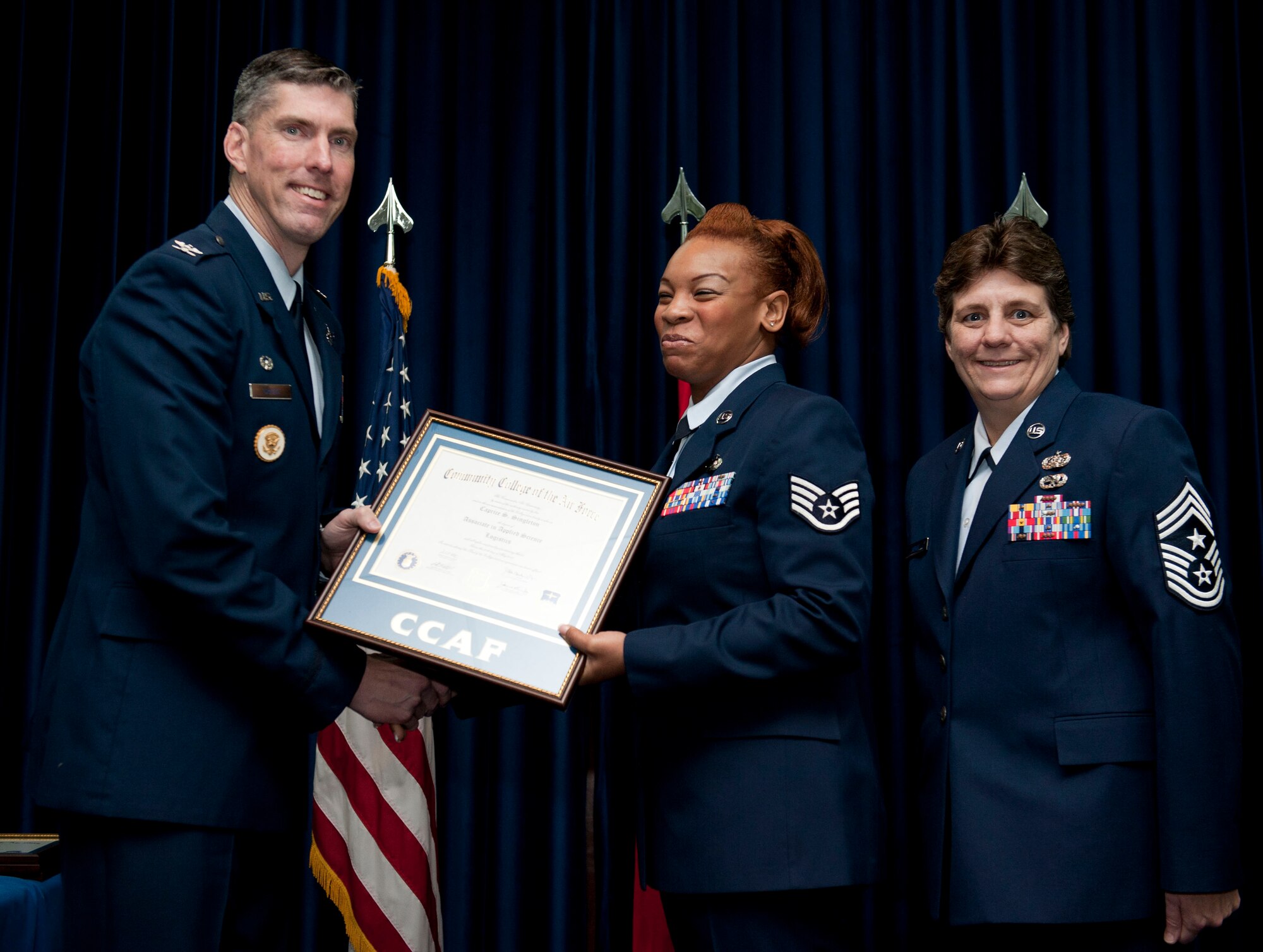 Staff Sgt. Caprice Singleton, 39th Logistics Readiness Squadron, is awarded a degree from the Community College of the Air Force Dec. 7, 2012, at Incirlik Air Base, Turkey. The CCAF offers enlisted members the opportunity to earn associate degrees that relate to their Air Force Specialty Code. (U.S. Air Force photo by Senior Airman Clayton Lenhardt/Released)