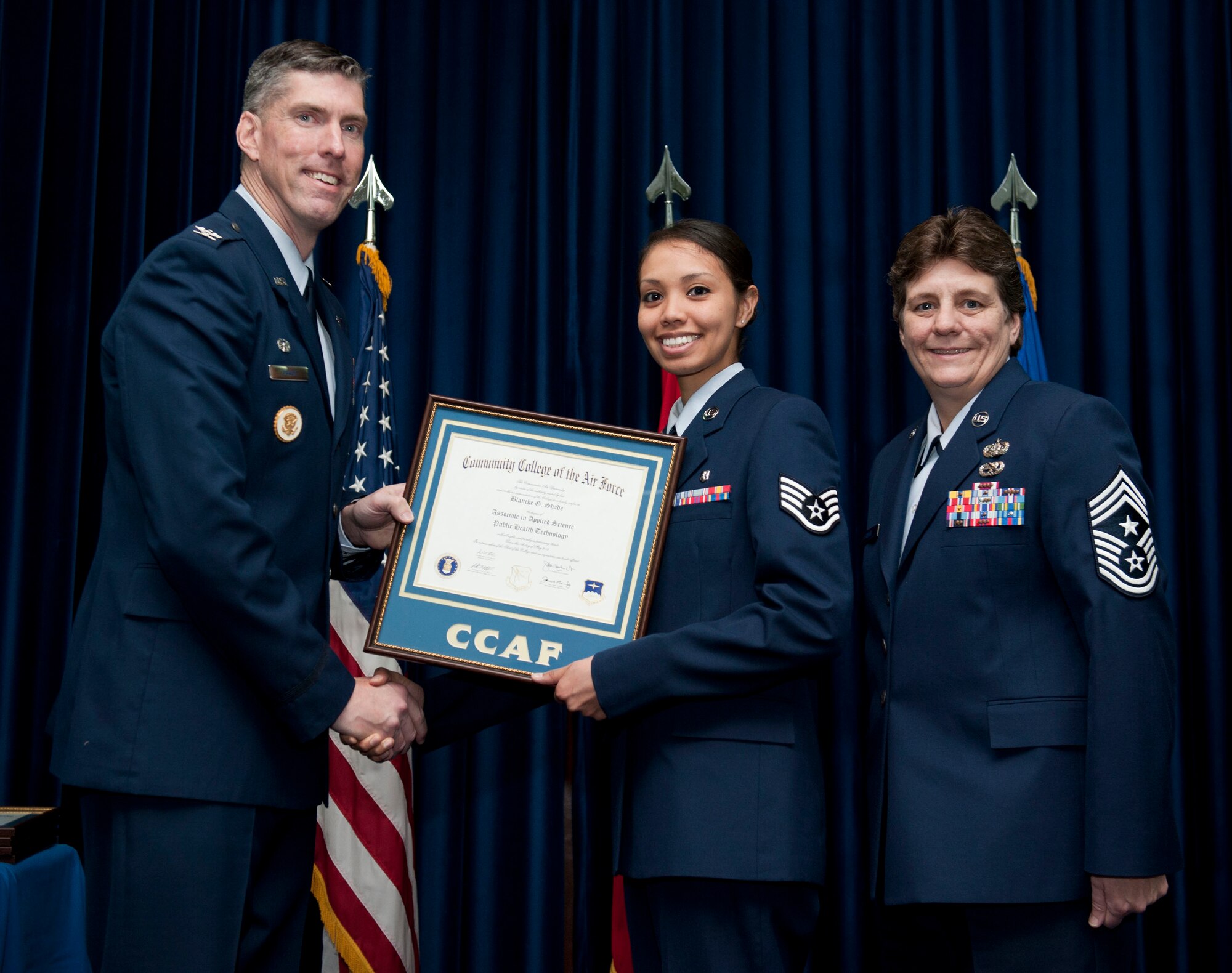 Staff Sgt. Blanche Shade, 39th Medical Operations Squadron, is awarded a degree from the Community College of the Air Force Dec. 7, 2012, at Incirlik Air Base, Turkey. The CCAF offers enlisted members the opportunity to earn associate degrees that relate to their Air Force Specialty Code. (U.S. Air Force photo by Senior Airman Clayton Lenhardt/Released)