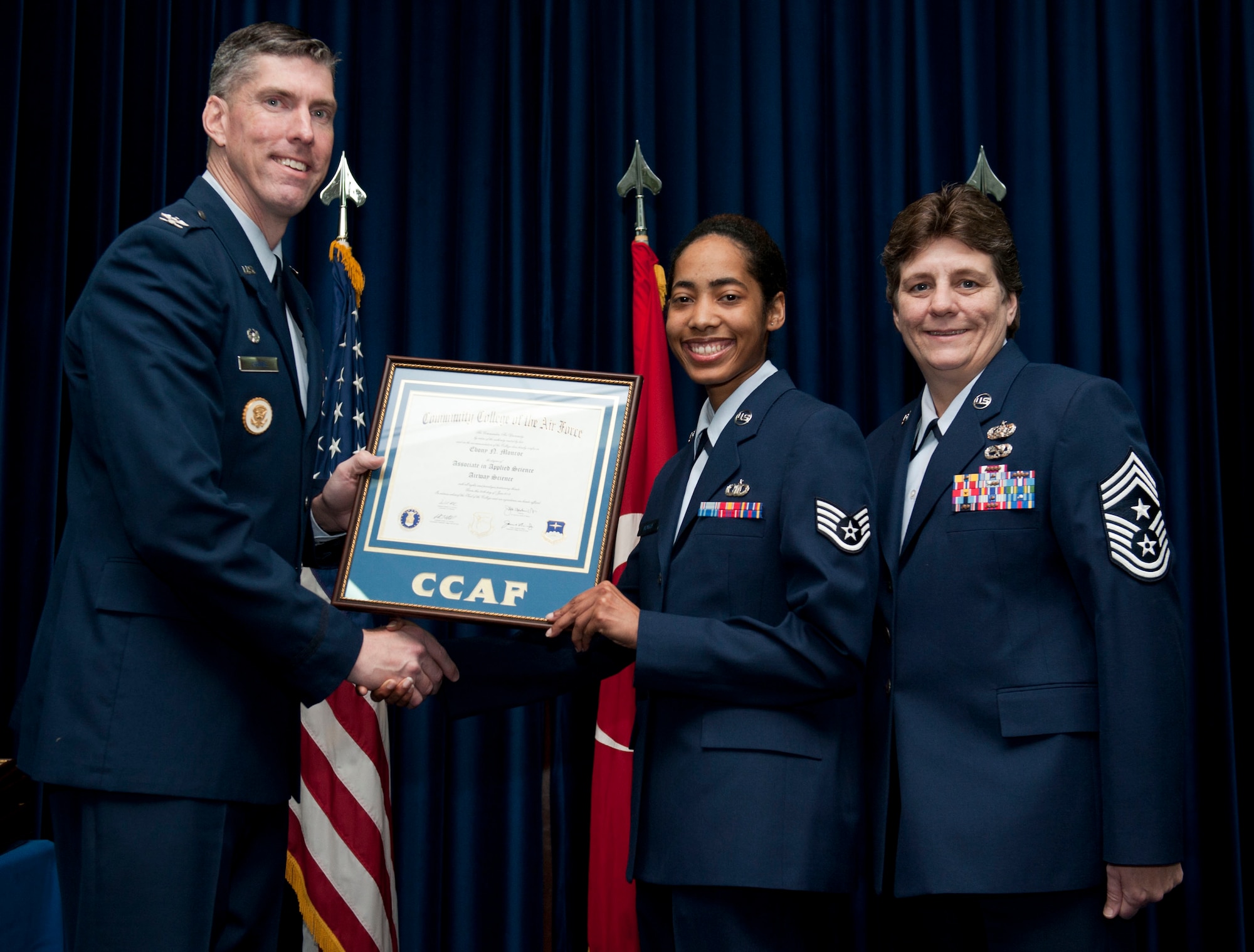 Staff Sgt. Ebony Monroe, 39th Operations Squadron, is awarded a degree from the Community College of the Air Force Dec. 7, 2012, at Incirlik Air Base, Turkey. The CCAF offers enlisted members the opportunity to earn associate degrees that relate to their Air Force Specialty Code. (U.S. Air Force photo by Senior Airman Clayton Lenhardt/Released)