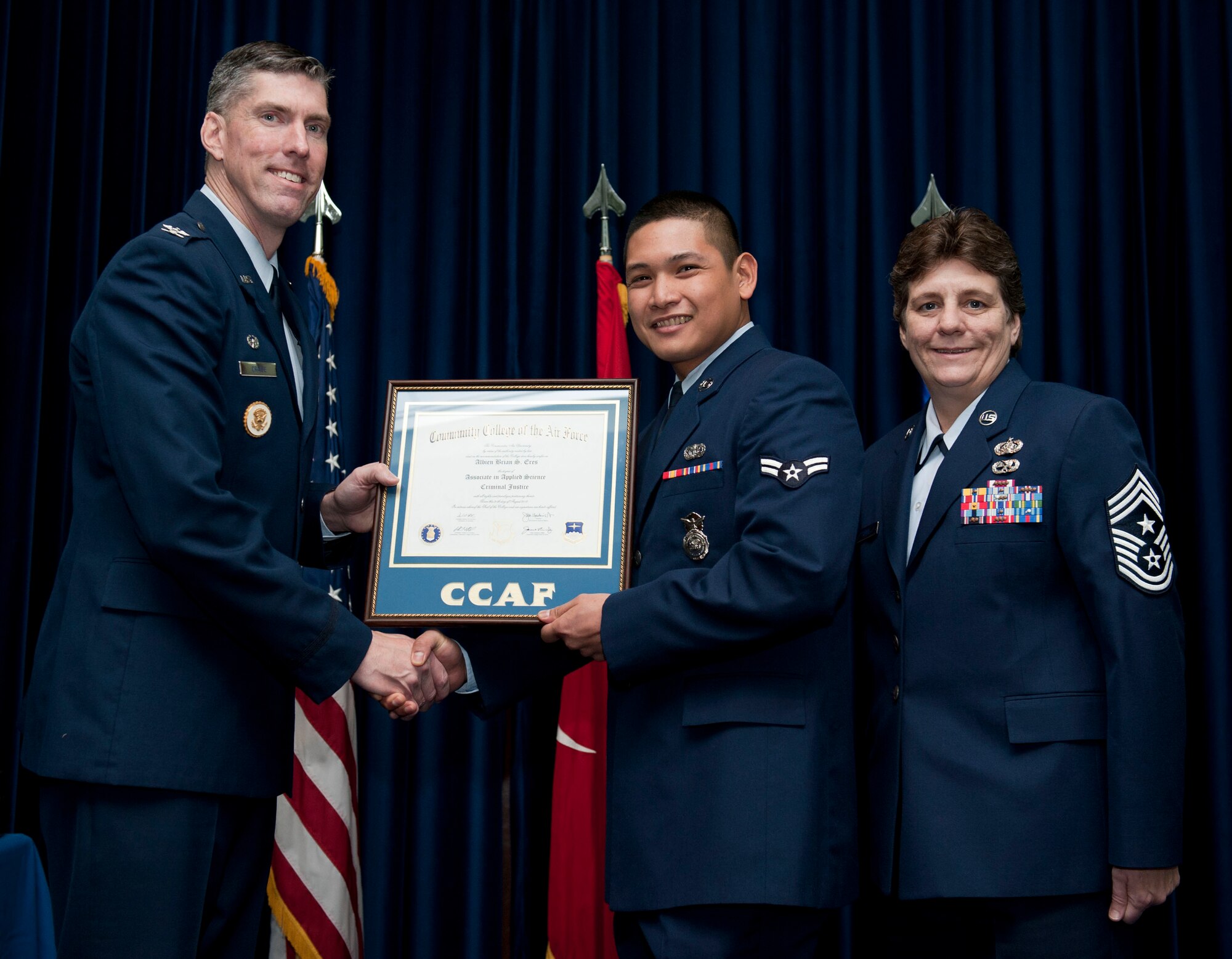 Airman 1st Class Albein Eres, 39th Security Forces Squadron, is awarded a degree from the Community College of the Air Force Dec. 7, 2012, at Incirlik Air Base, Turkey. The CCAF offers enlisted members the opportunity to earn associate degrees that relate to their Air Force Specialty Code. (U.S. Air Force photo by Senior Airman Clayton Lenhardt/Released)