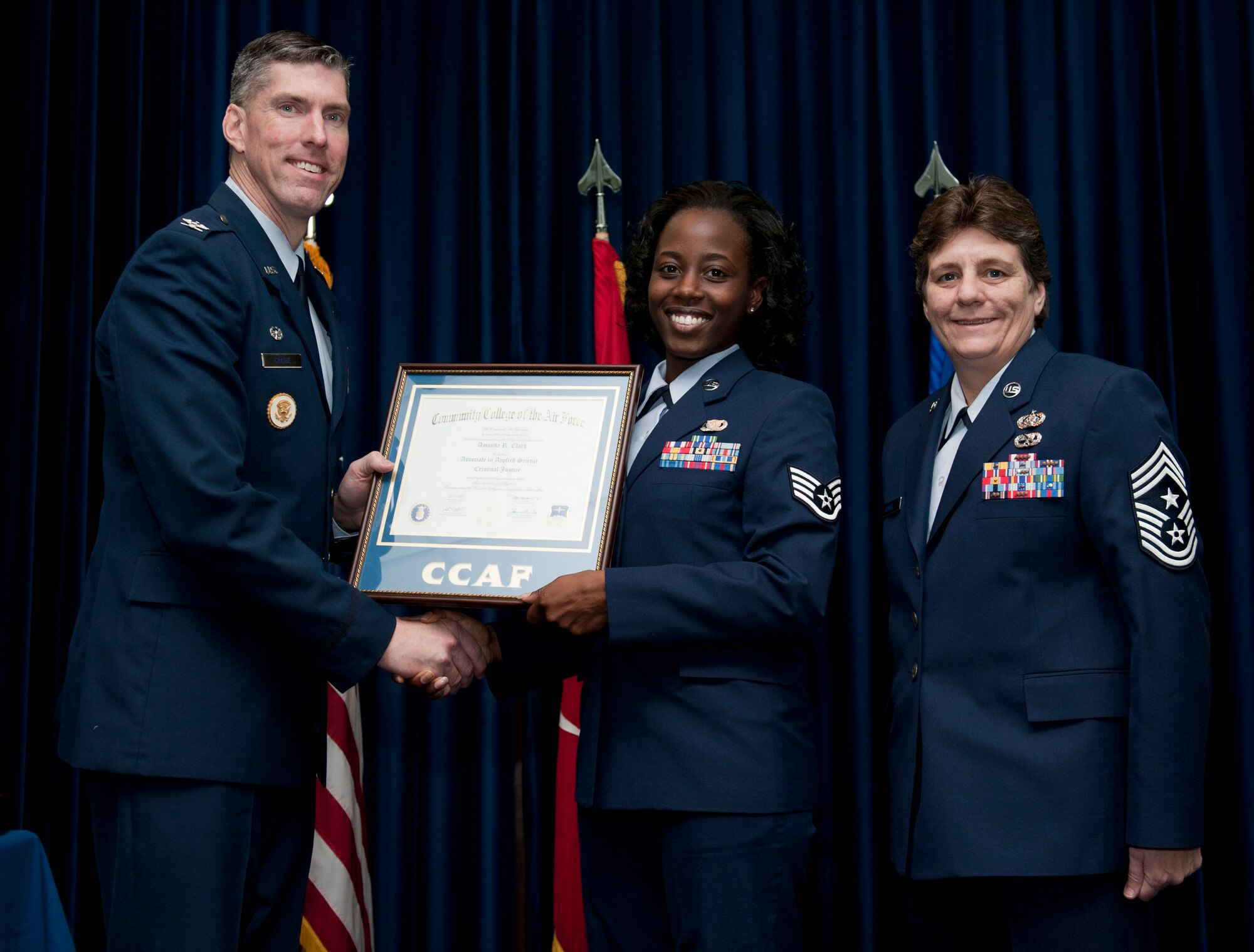 Staff Sgt. Amanda Clark, 39th Security Forces Squadron, is awarded a degree from the Community College of the Air Force Dec. 7, 2012, at Incirlik Air Base, Turkey. The CCAF offers enlisted members the opportunity to earn associate degrees that relate to their Air Force Specialty Code. (U.S. Air Force photo by Senior Airman Clayton Lenhardt/Released)