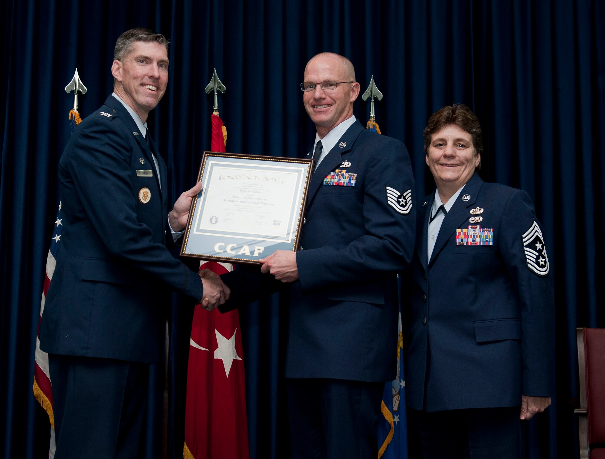 Tech. Sgt. Lance Carlson, 39th Maintenance Squadron, is awarded a degree from the Community College of the Air Force Dec. 7, 2012, at Incirlik Air Base, Turkey. The CCAF offers enlisted members the opportunity to earn associate degrees that relate to their Air Force Specialty Code. (U.S. Air Force photo by Senior Airman Clayton Lenhardt/Released)