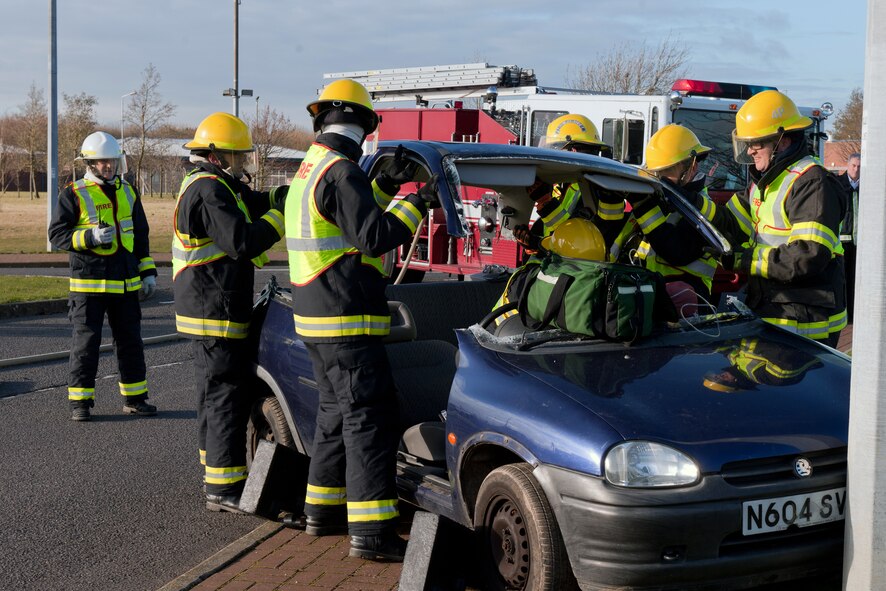 RAF MOLESWORTH, United Kingdom – Members of the 423rd Civil Engineer Squadron fire department remove the roof of a car involved in a simulated traffic accident on RAF Molesworth Dec. 10. The 423rd Security Forces Squadron and 423rd CES fire department conducted the vehicle extrication and field sobriety test exercise at the intersection of 358th and 359th streets as a reminder to remain safe throughout the holiday and winter seasons. (U.S. Air Force photo by Staff Sgt. Brian Stives)