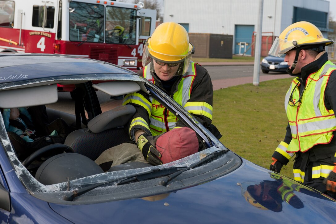 RAF MOLESWORTH, United Kingdom – Members of the 423rd Civil Engineer Squadron fire department stabilize the “passenger” of a car at a simulated traffic accident on RAF Molesworth Dec. 10. The 423rd Security Forces Squadron and 423rd CES fire department conducted the vehicle extrication and field sobriety test exercise at the intersection of 358th and 359th streets as a reminder to remain safe throughout the holiday and winter seasons. (U.S. Air Force photo by Staff Sgt. Brian Stives)